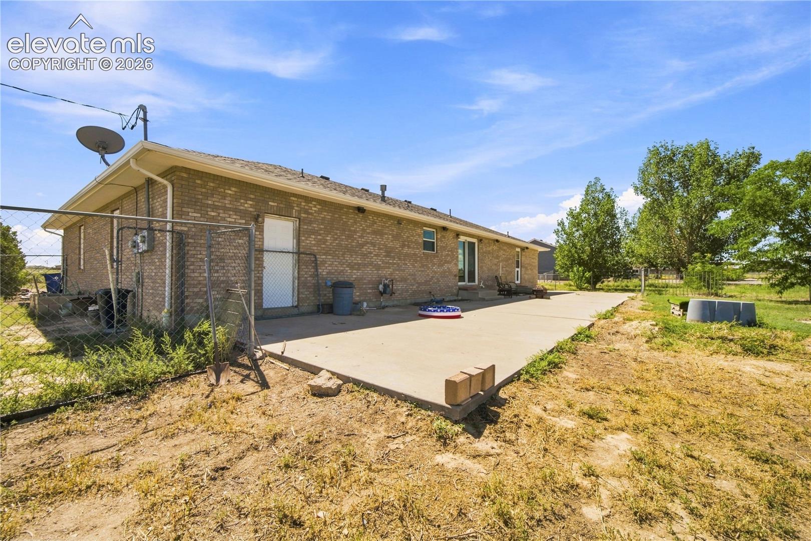 Brick exterior with an extended concrete patio