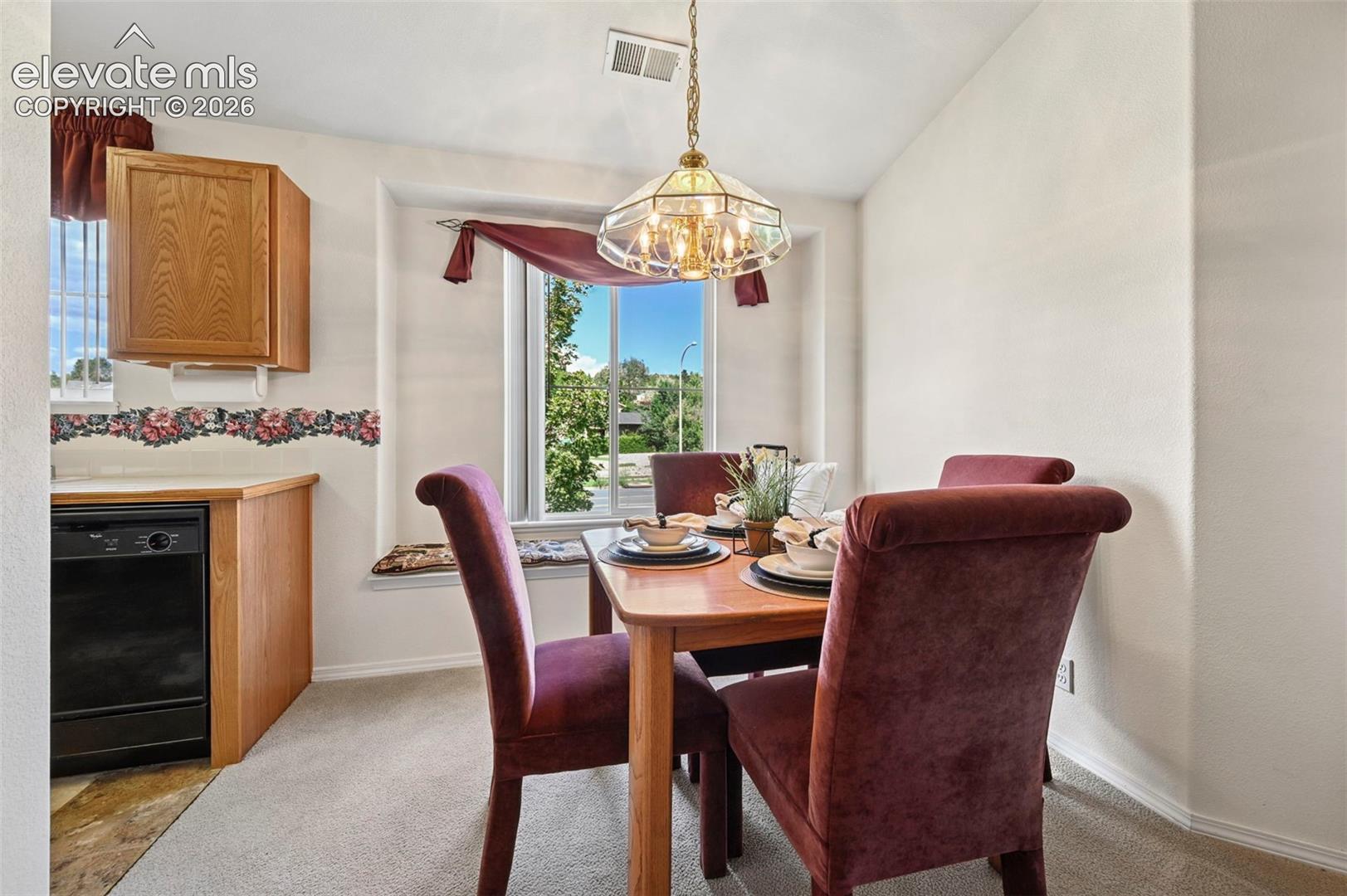 Dining room with bay window seating and mountain views