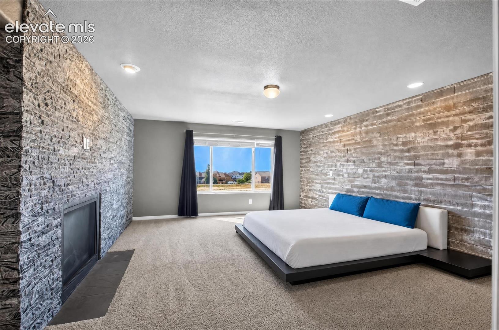 Stone accent wall with a built-in fireplace