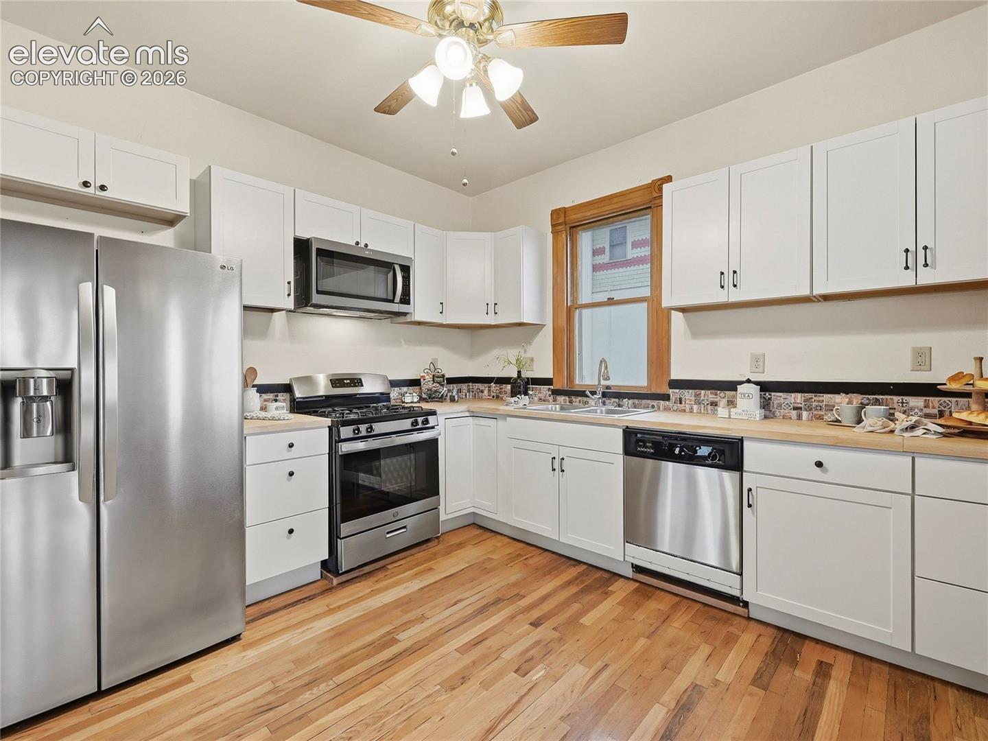 Updated kitchen w/butcher block countertops and tile backsplash.