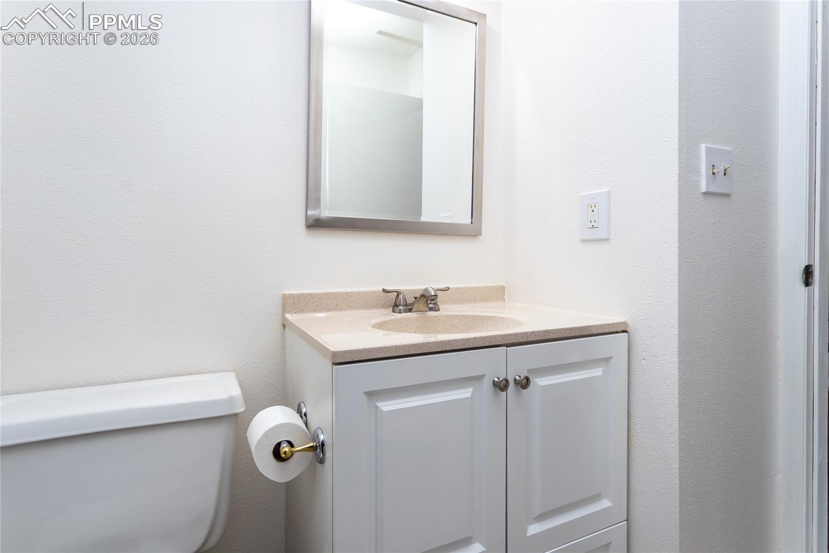 Half bath with vanity and toilet