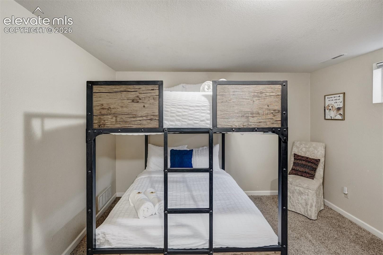 Industrial-style bunk bed featuring a metal frame and wood-finish panels