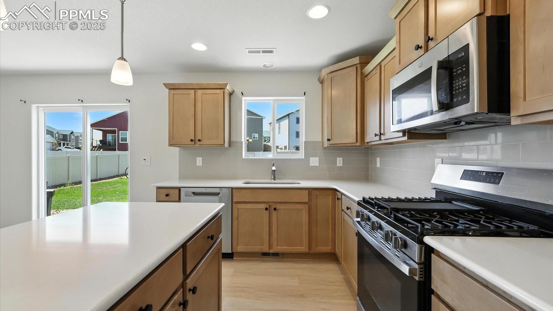 Ample cabinetry and countertops for kitchen storage and easy food preparation.