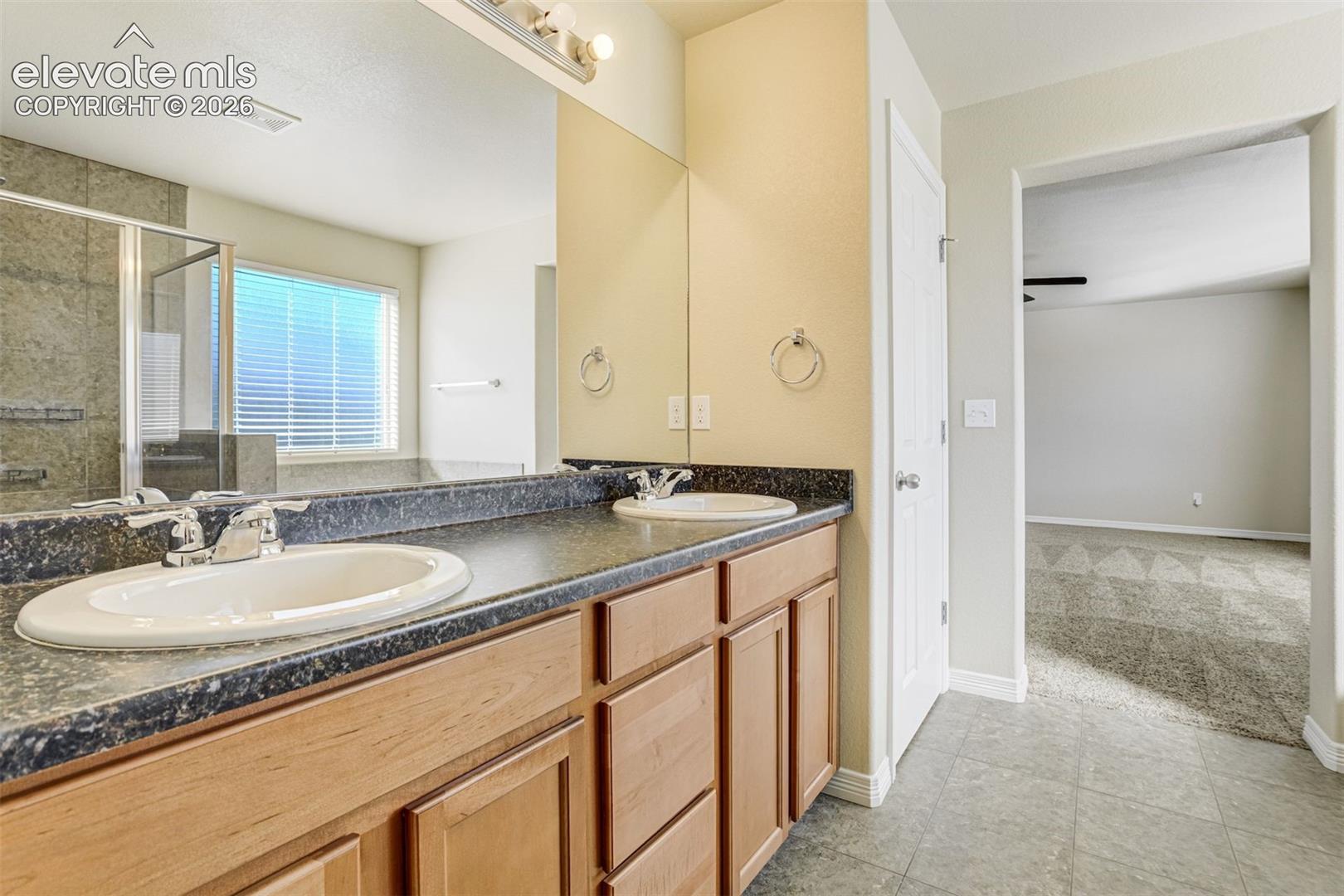 Dual vanity with dark countertops