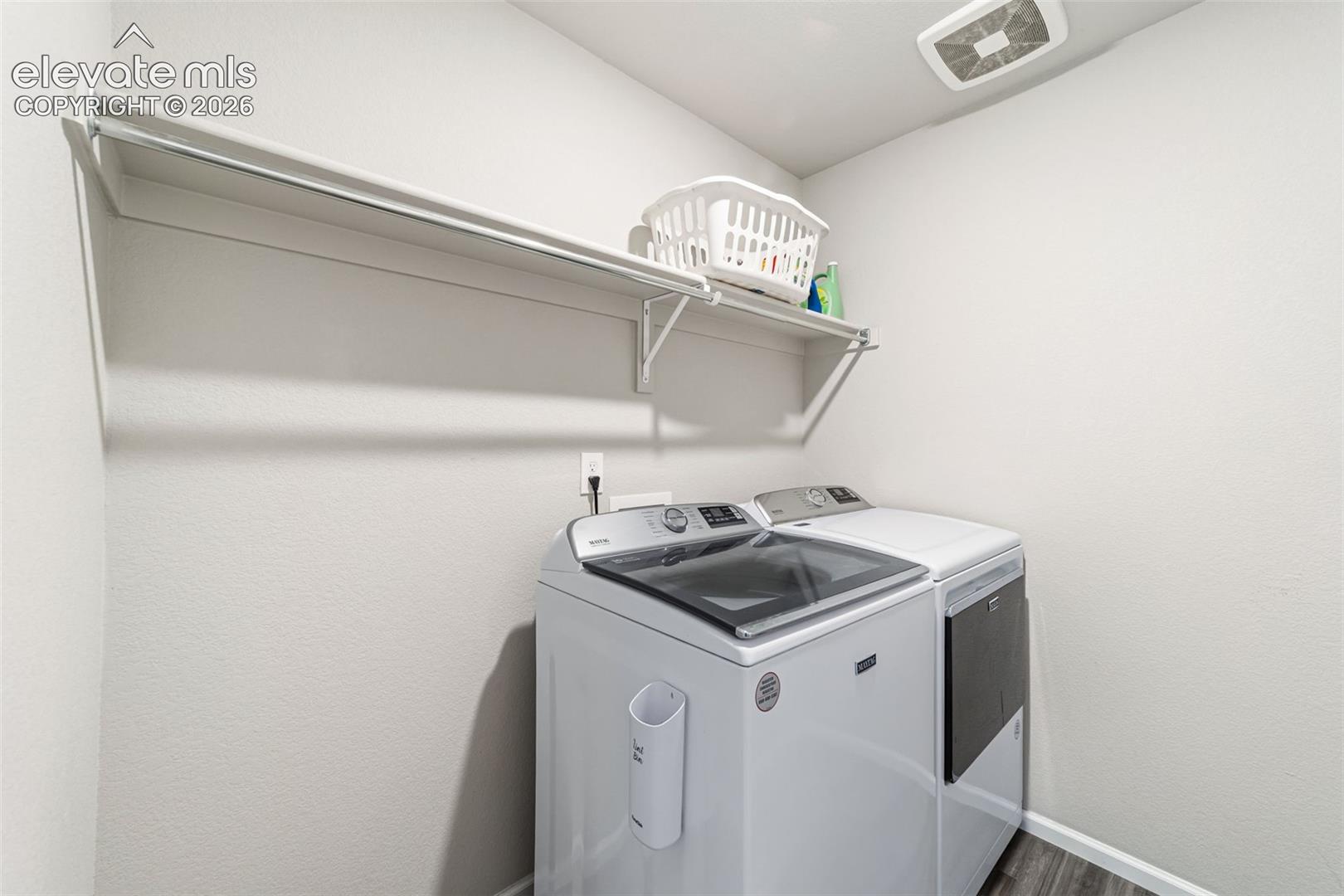 Convenient upper-level laundry room with built-in shelving.
