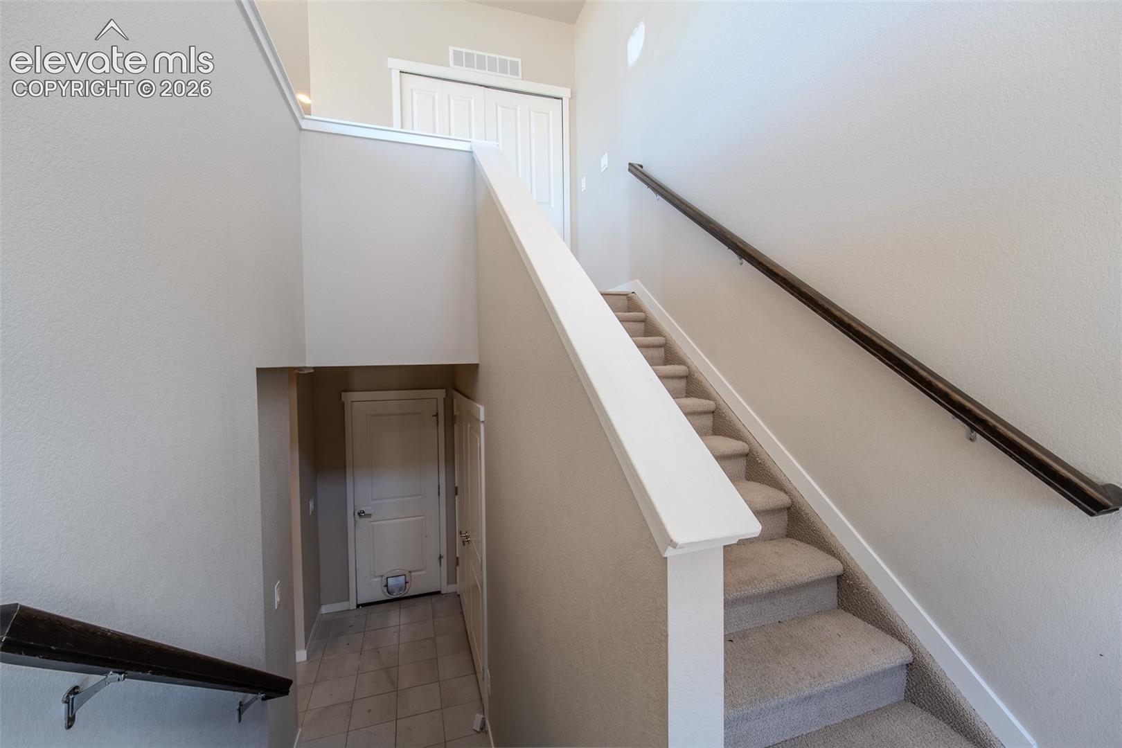 Lower Level tiled front entry with stairs to the upper level.