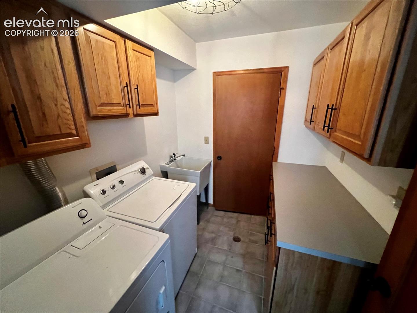  Custom Cottage: Laundry room at the entrance with a storage room behind