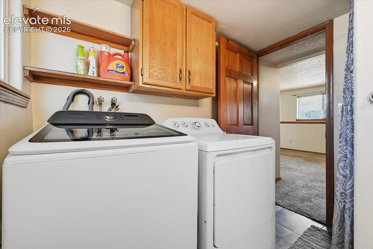 Built-in wood cabinetry, integrated shelving, and tile flooring