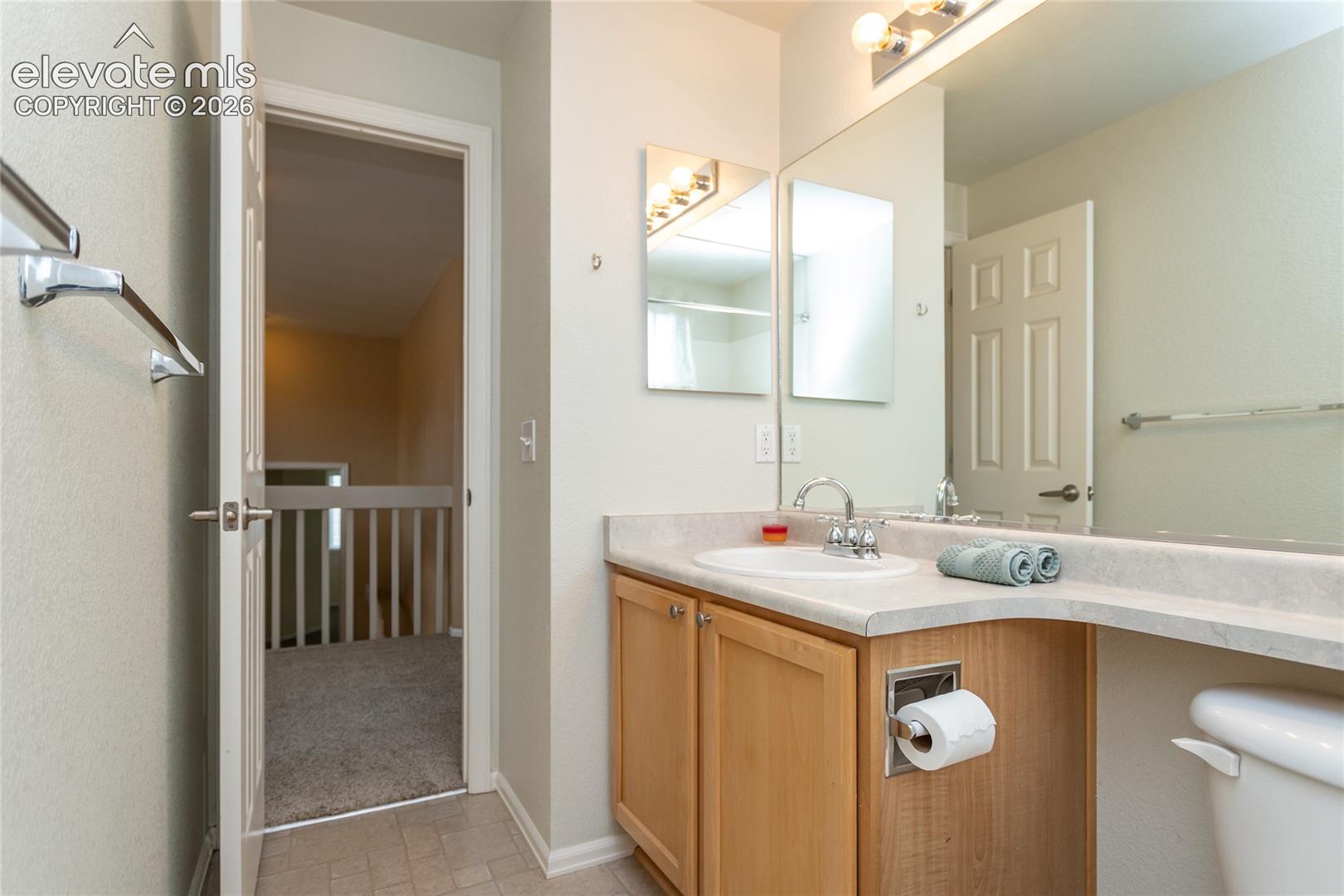 Upper level full bathroom looking out to the hallway