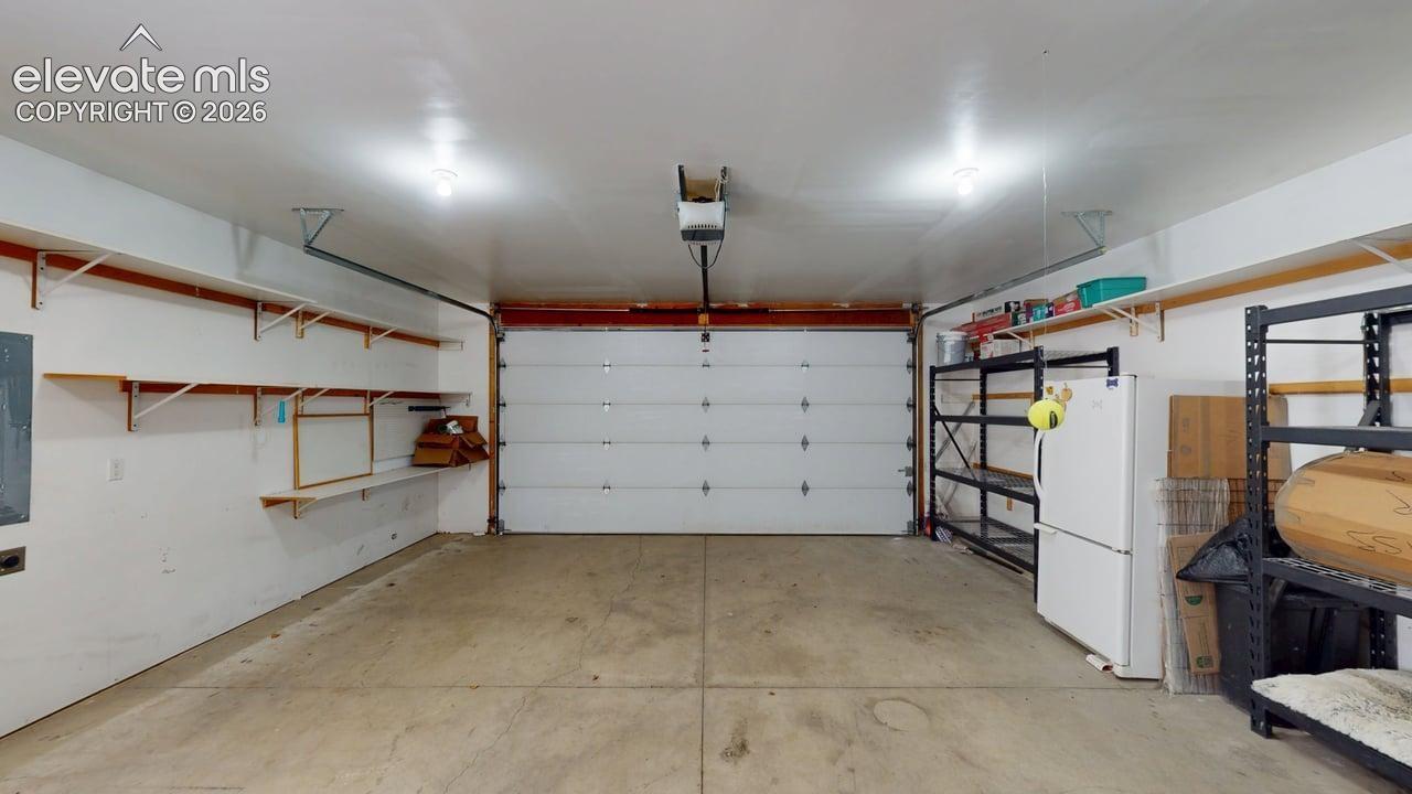 Garage with overhead lighting and a single overhead door