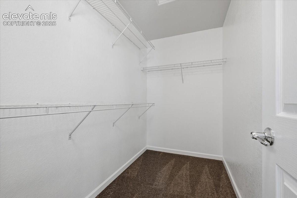 Primary Bedroom Walk-in closet with multiple wire shelving units