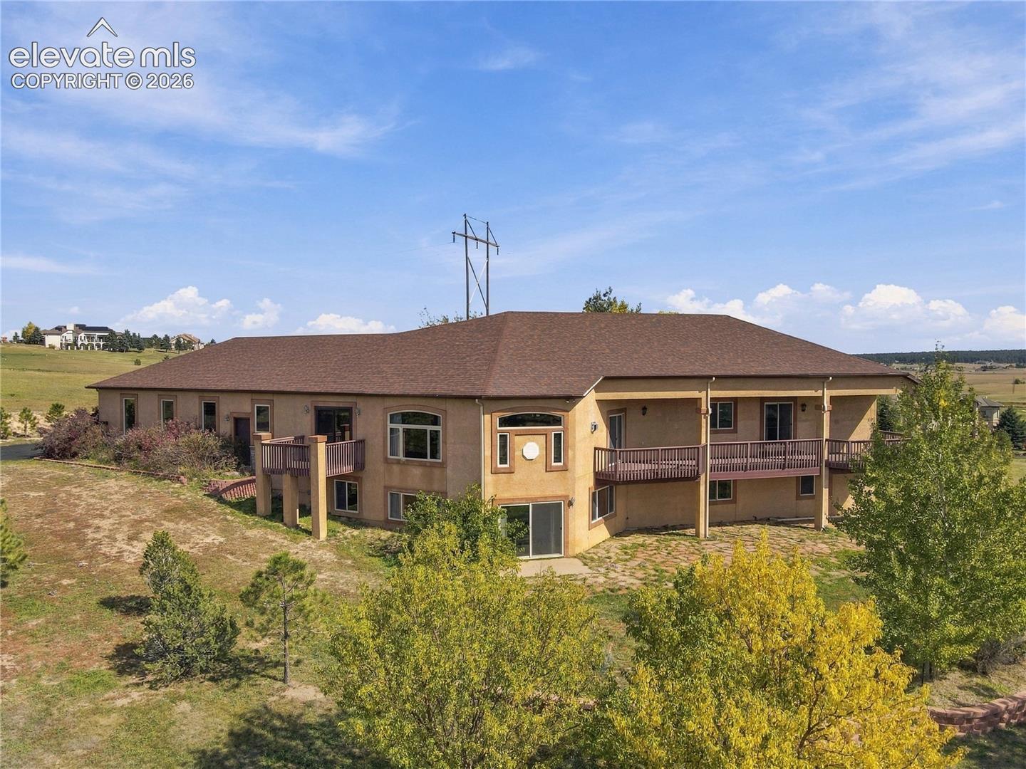 Multiple balconies, a lower patio, and windows framing picture-perfect mountain views