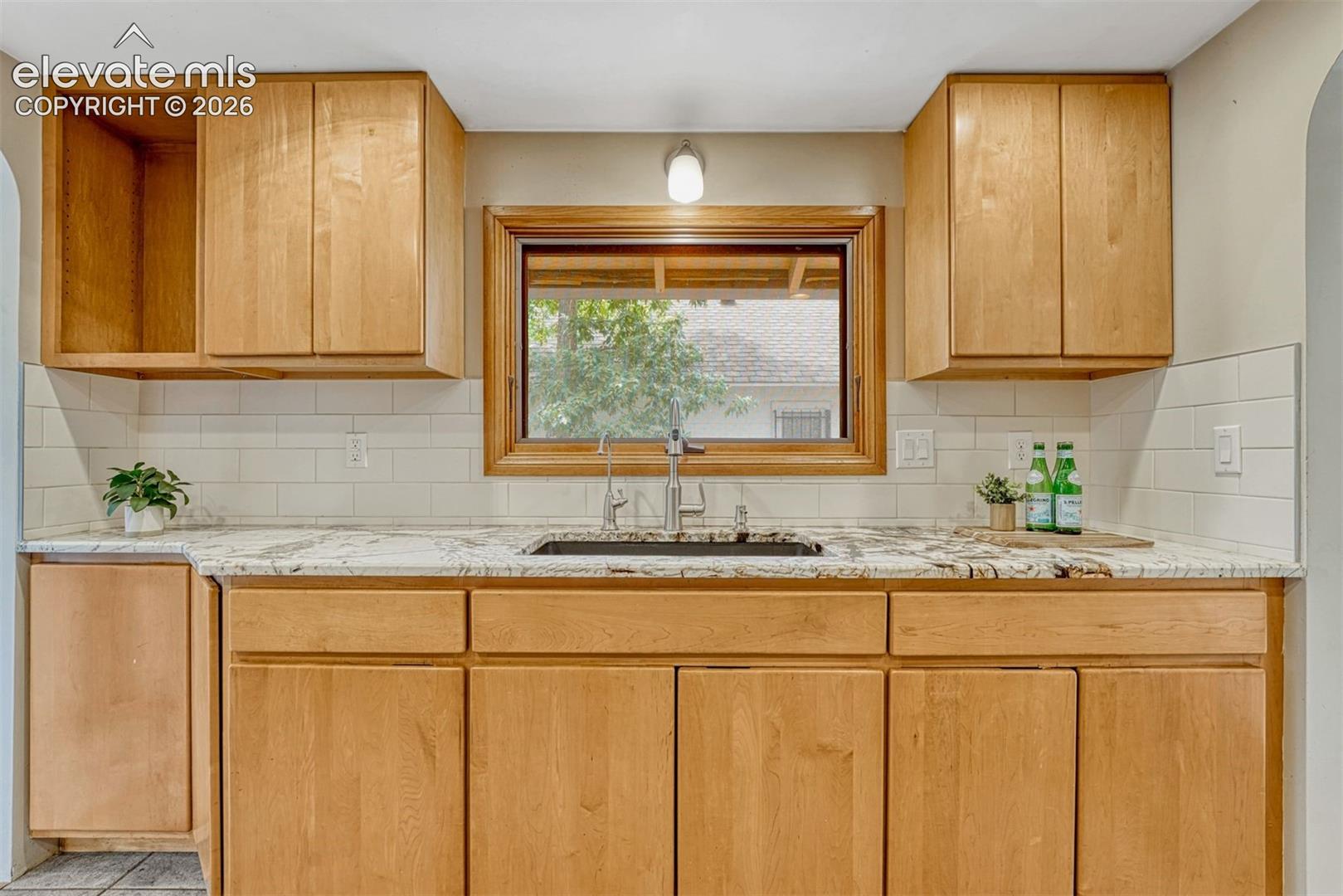 Updated cabinets, sink, and lots of granite counter space