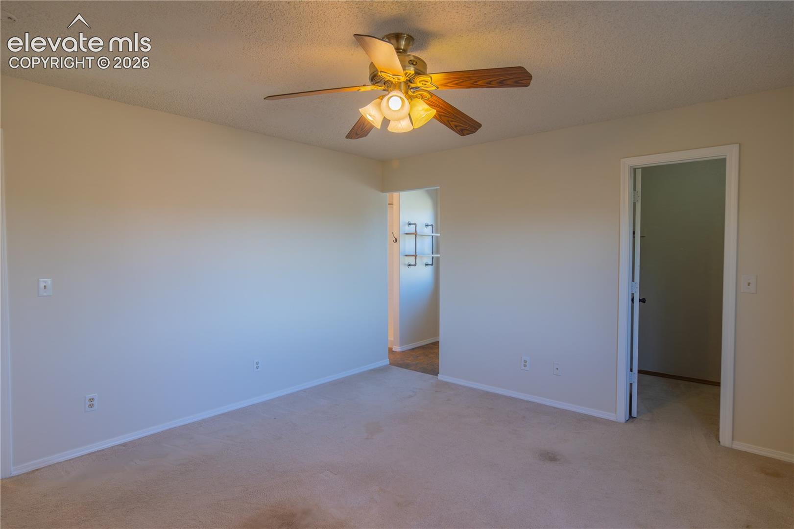 Another view of the generously sized primary bedroom and its private bathroom access.