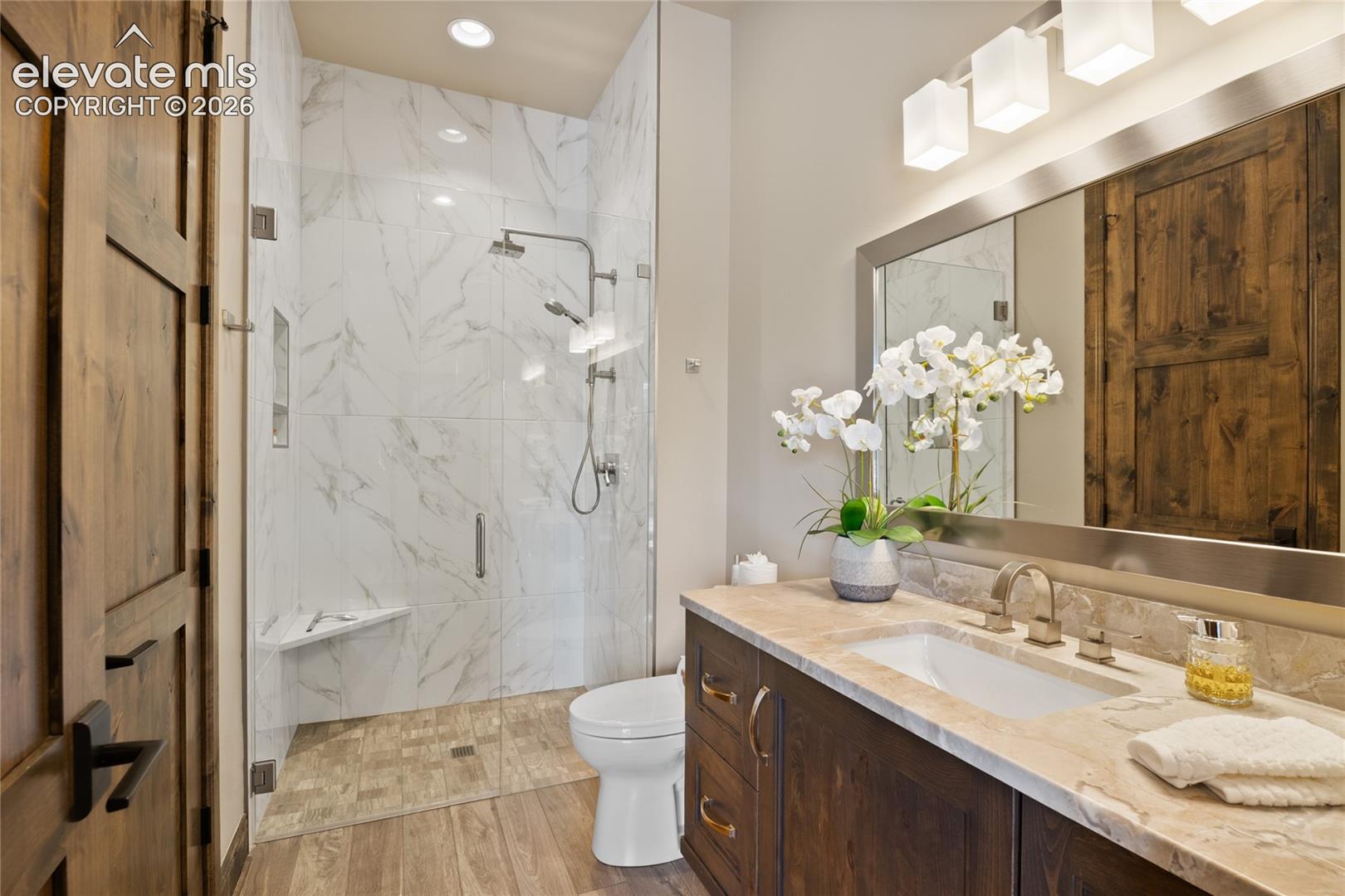 Guests will never want to leave. Private ensuite bath with curbless walk-in marble shower, custom wood vanity, and spa-worthy finishes throughout.
