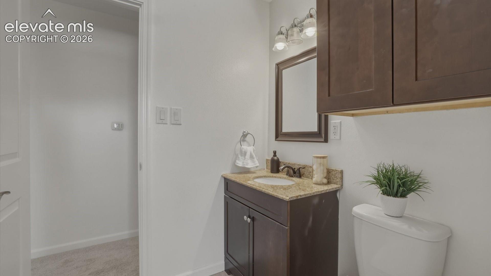 Upper Level Full Bathroom with vanity and framed mirror.