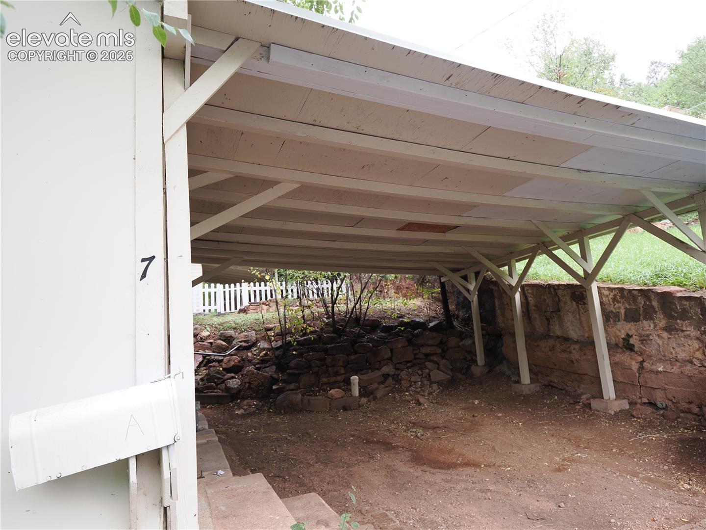 carport and street parking in front of the cottage 
