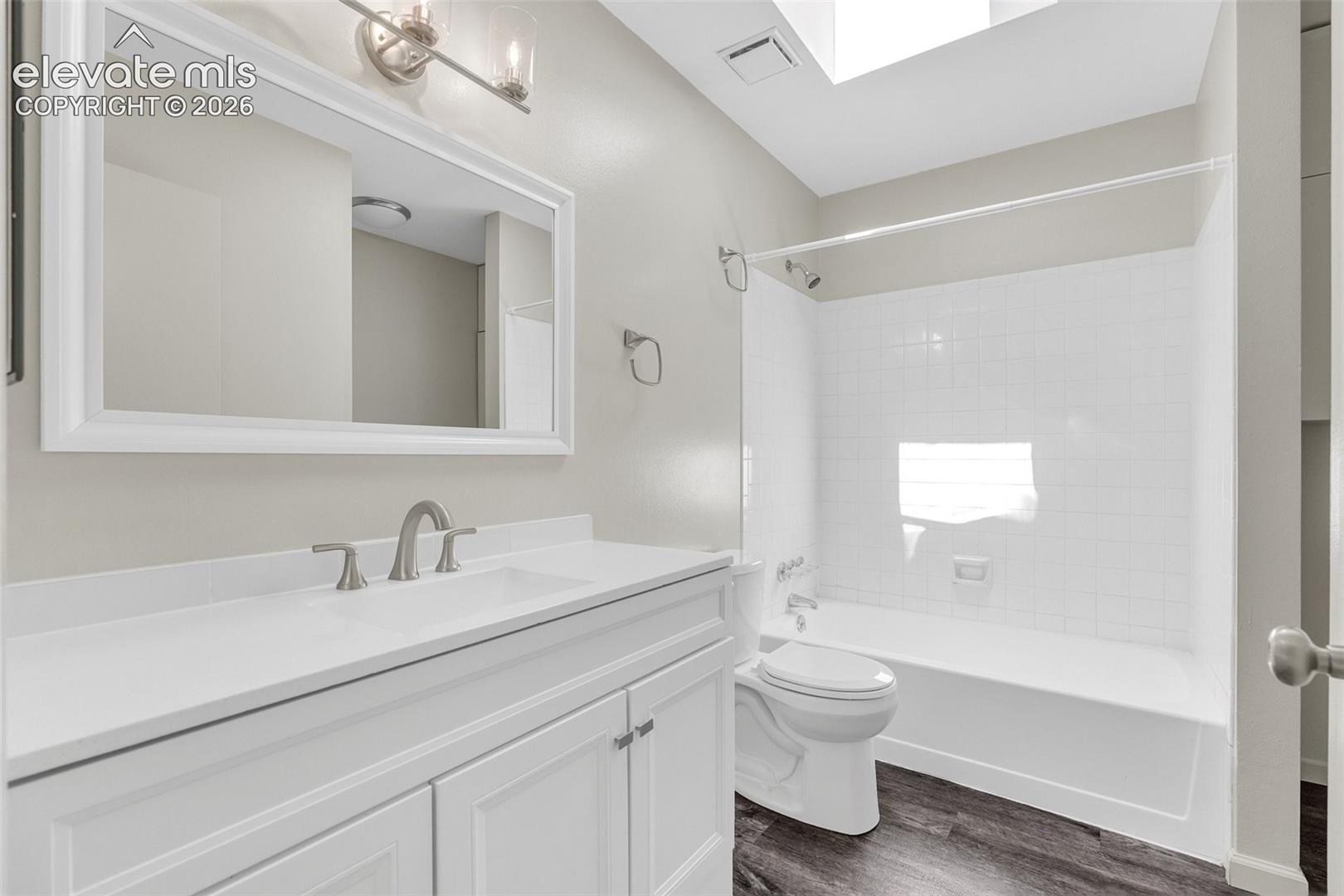 White vanity with panel doors and a white countertop