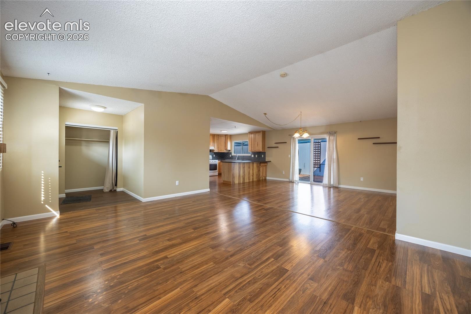 Vaulted ceilings complement wood-finish flooring throughout