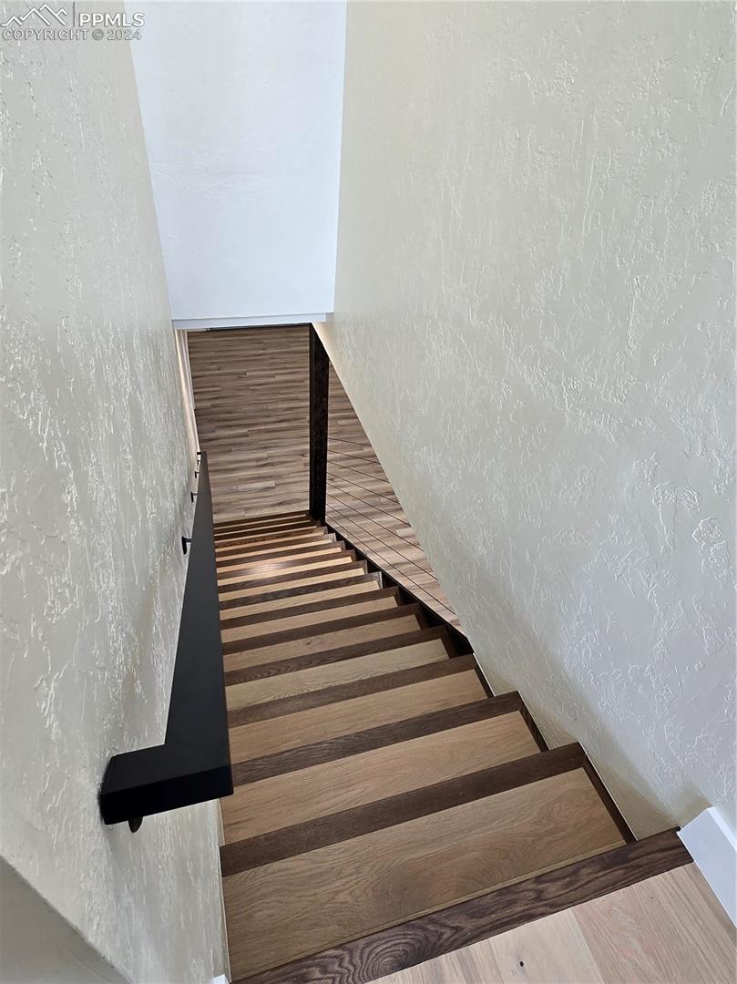 Stairs with hardwood / wood-style flooring
