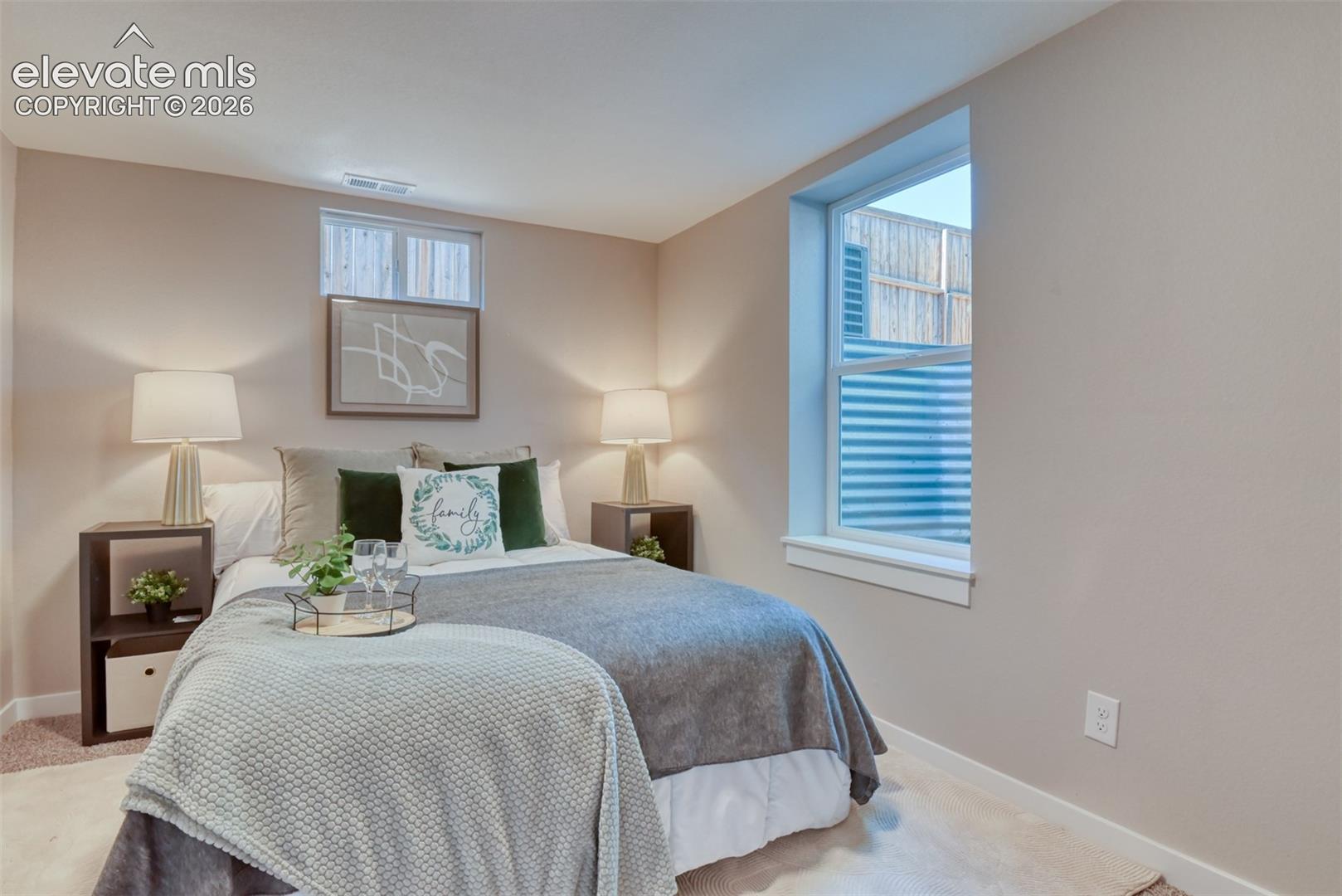 Neutral-toned walls complement the carpeted flooring