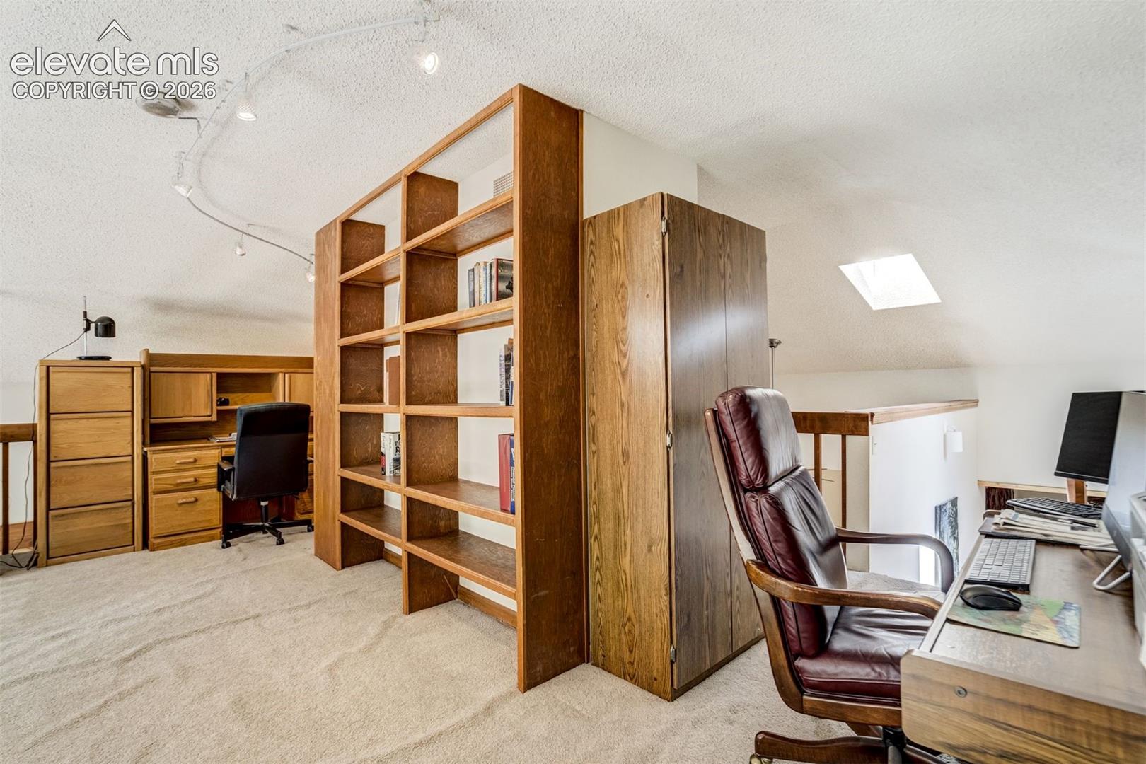 Built in bookshelves in the loft that is now used as an office
