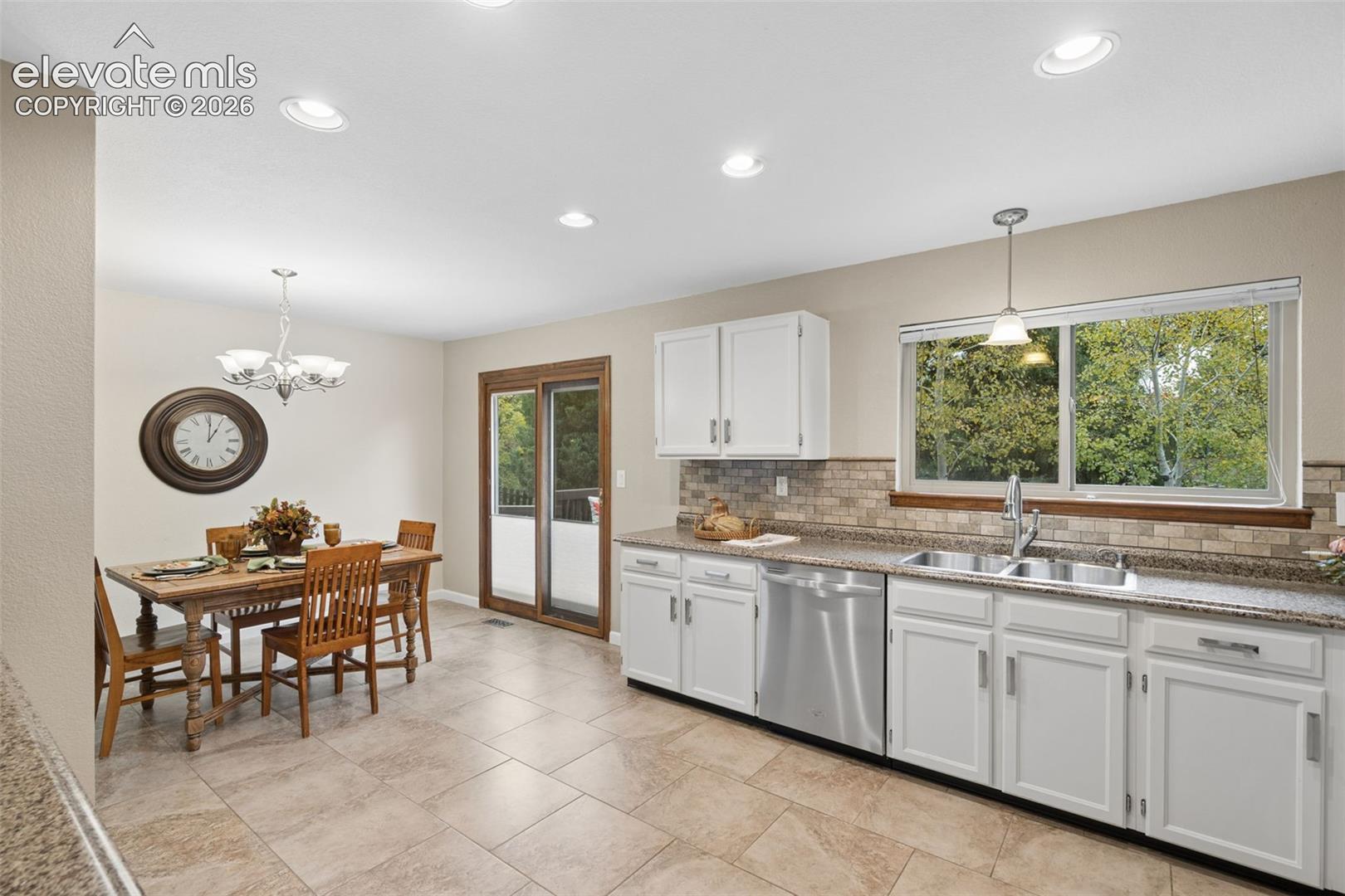 Pella sliding door w/enclosed blinds .  Tile flooring throughout kitchen and dining room make for easy cleanup