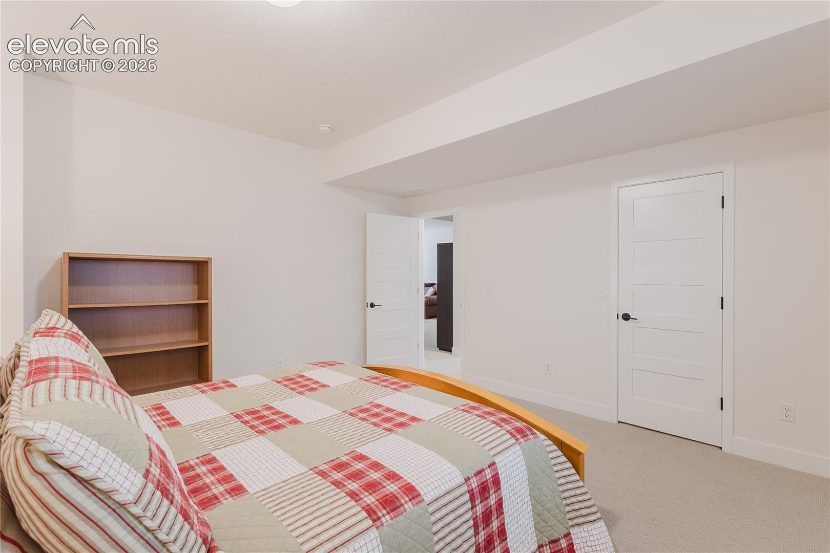 Bedroom in the lower level with plantation shutters and a walk in closet