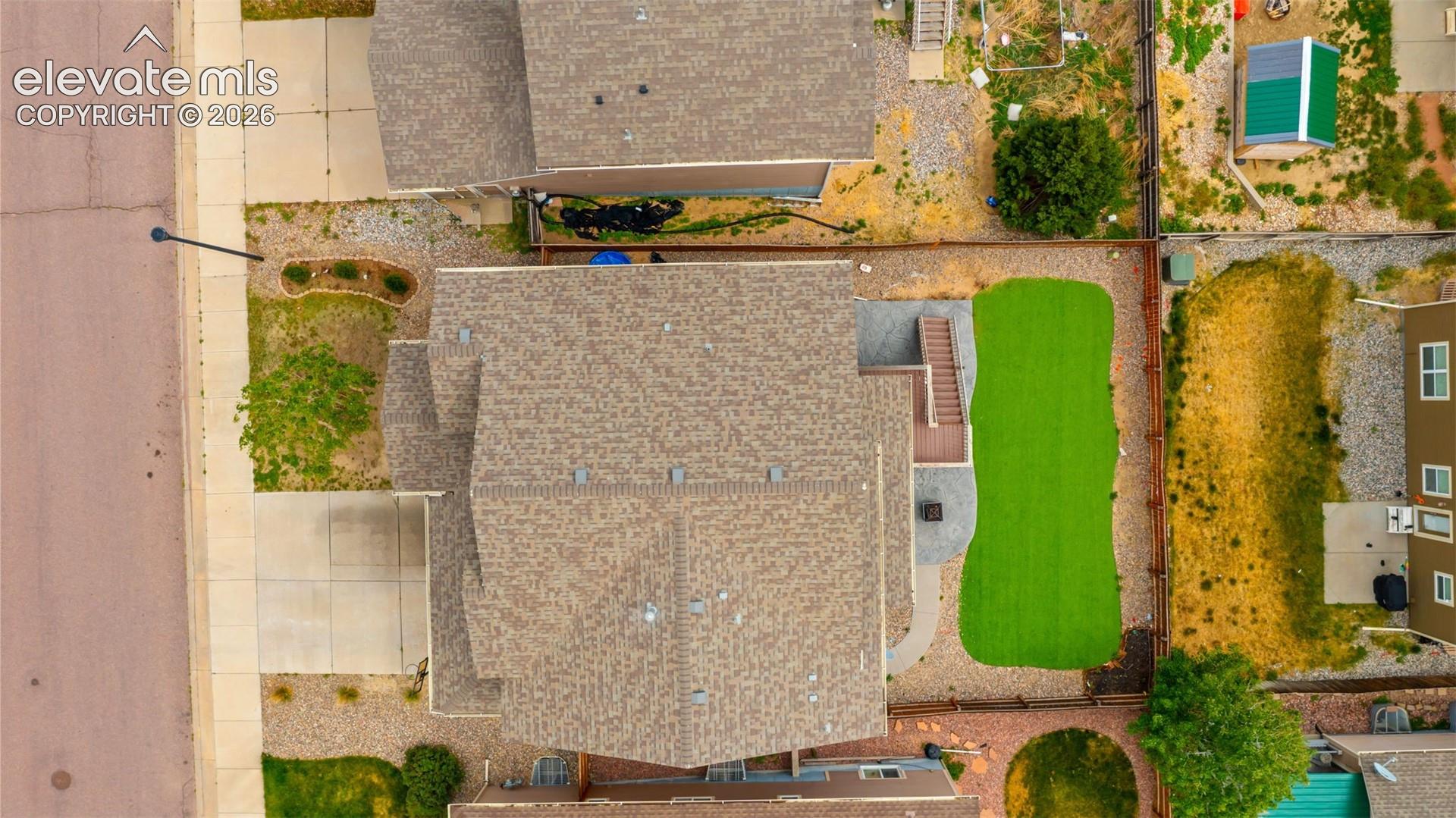 Aerial perspective showcasing the backyard with artificial turf