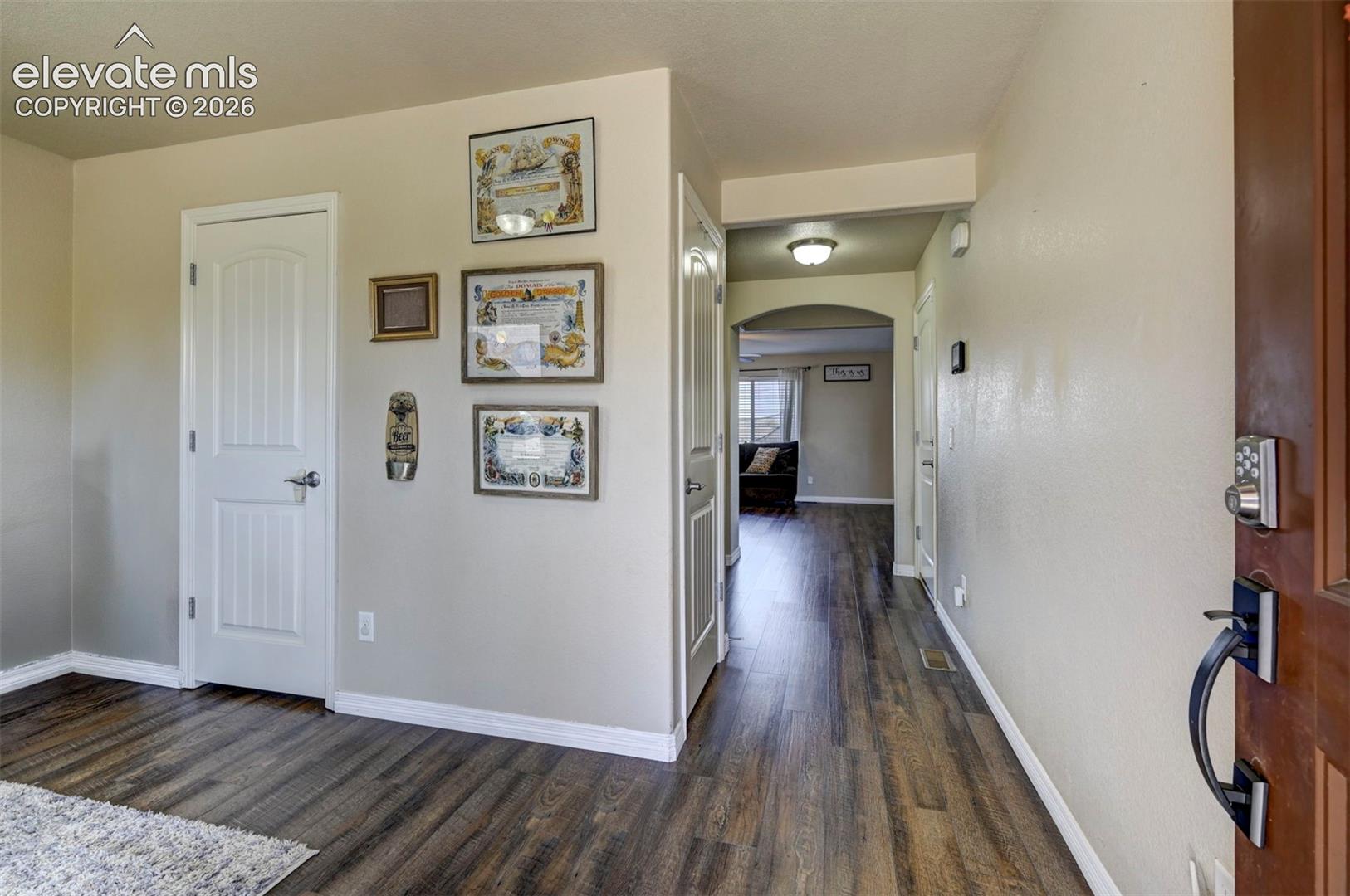 Wood-finish flooring, white trim, and neutral wall tones