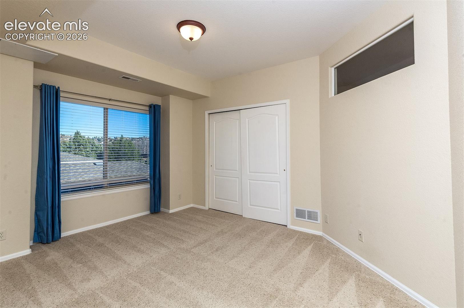 2nd bedroom with interior glass for additional light from living room