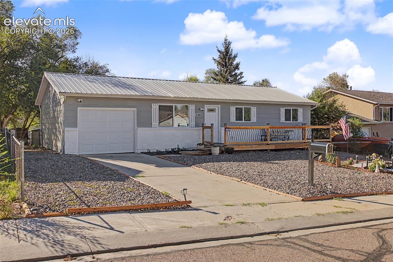 Welcome to this completely renovated, move-in-ready home featuring modern updates, stylish finishes, and convenient main-level living! Enjoy beautiful Pikes Peak views from the brand-new oversized front deck with attractive metal and wood railings. Inside, hardwood floors flow throughout the open-concept floor plan, complemented by recessed lighting and an inviting electric fireplace. The beautifully updated kitchen features quartz countertops, soft-close cabinetry, a tile backsplash, a kitchen island, and brand-new stainless steel appliances, including a gas range. The kitchen also offers a walkout to the backyard, creating an easy connection between indoor and outdoor living. The primary suite features an updated bathroom with built-in storage niches and Bluetooth speaker in the ceiling. The laundry room is thoughtfully designed with a stylish barn door and a convenient hall tree with cabinets and hooks for added organization. Extensive upgrades include a durable metal roof, new windows, updated plumbing and electrical, a new high-efficiency furnace, a new water heater, additional interior wall insulation, and central air conditioning. The front yard features water-efficient landscaping, while mature trees add charm and character to the property. With modern finishes, and extensive improvements throughout, this beautifully refreshed home offers comfort, efficiency, and contemporary style.