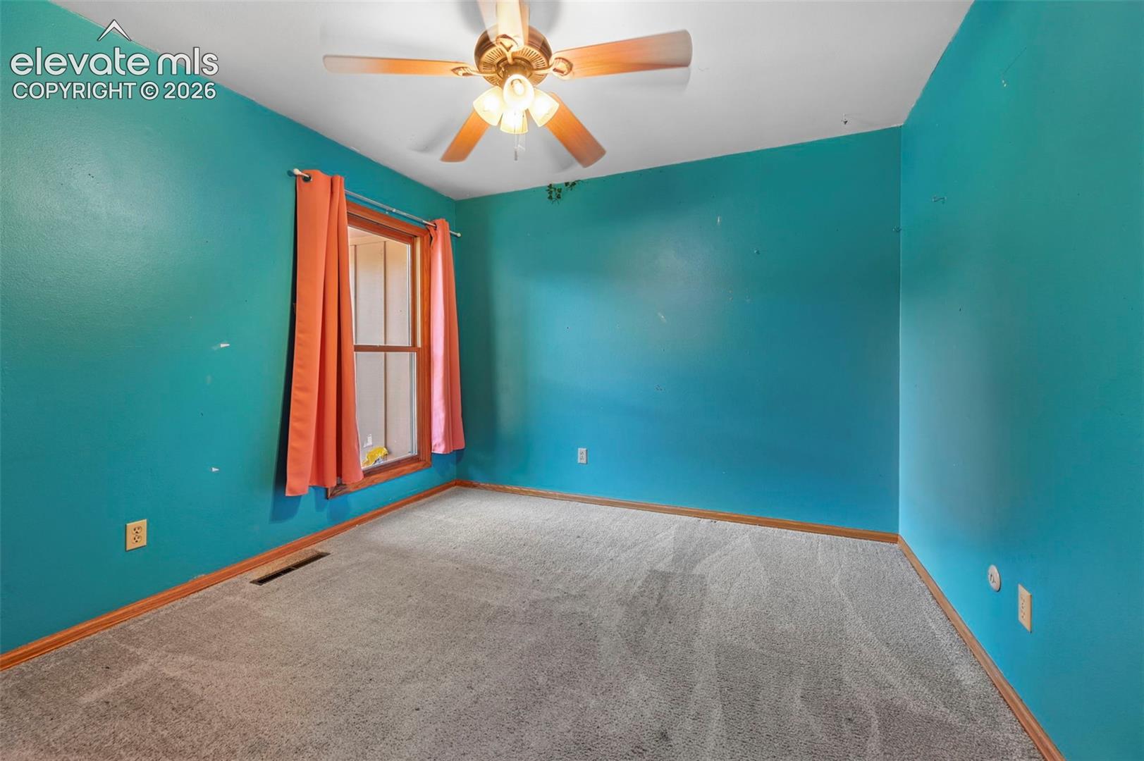 Carpeted flooring, single window, and a ceiling fan with light fixture
