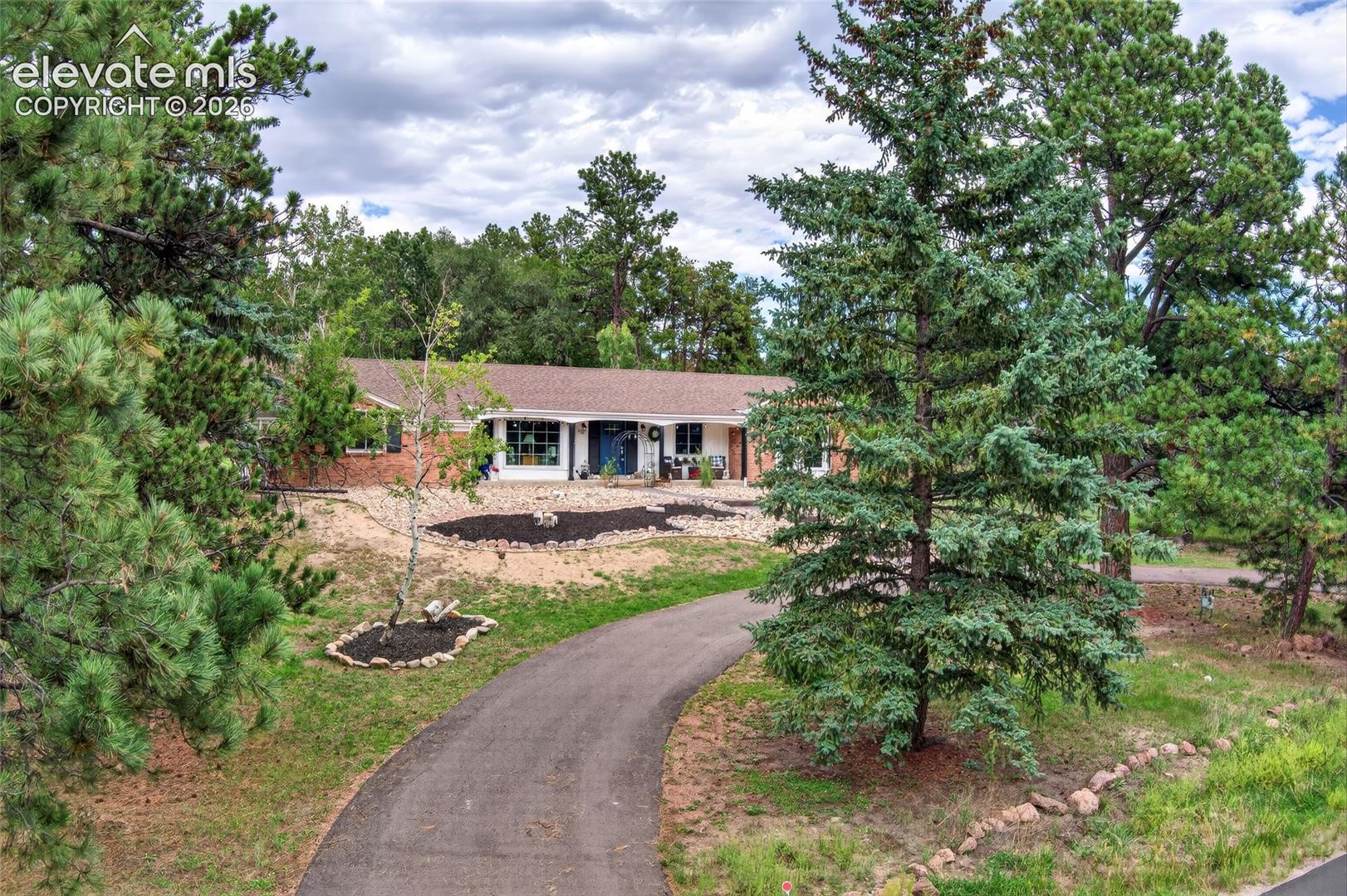Winding paved driveway leading to the residence