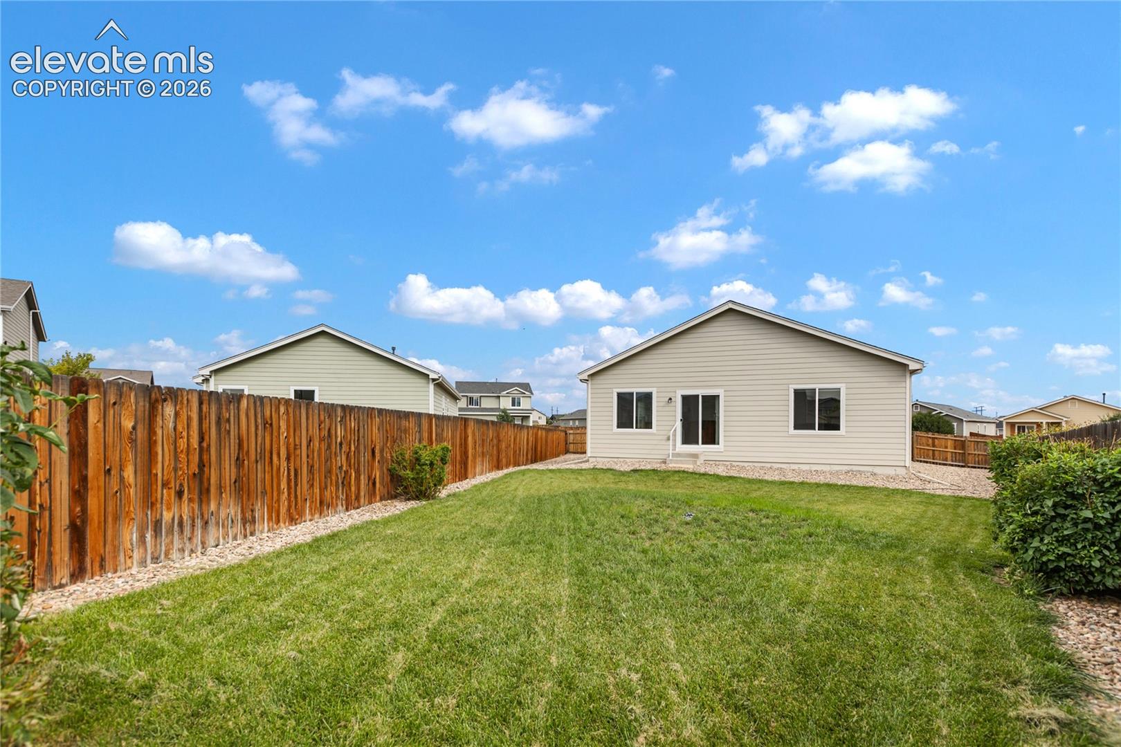 Spacious, level, fenced back yard