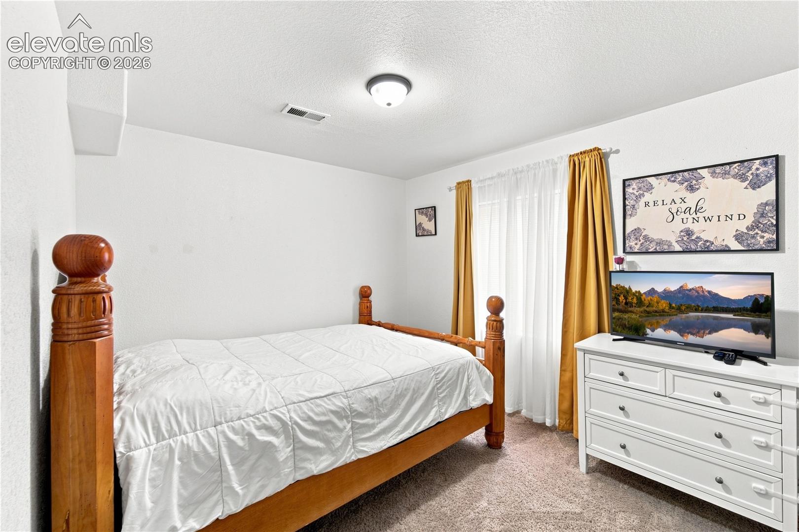 Recessed lighting fixture and a window with sheer and solid drapes