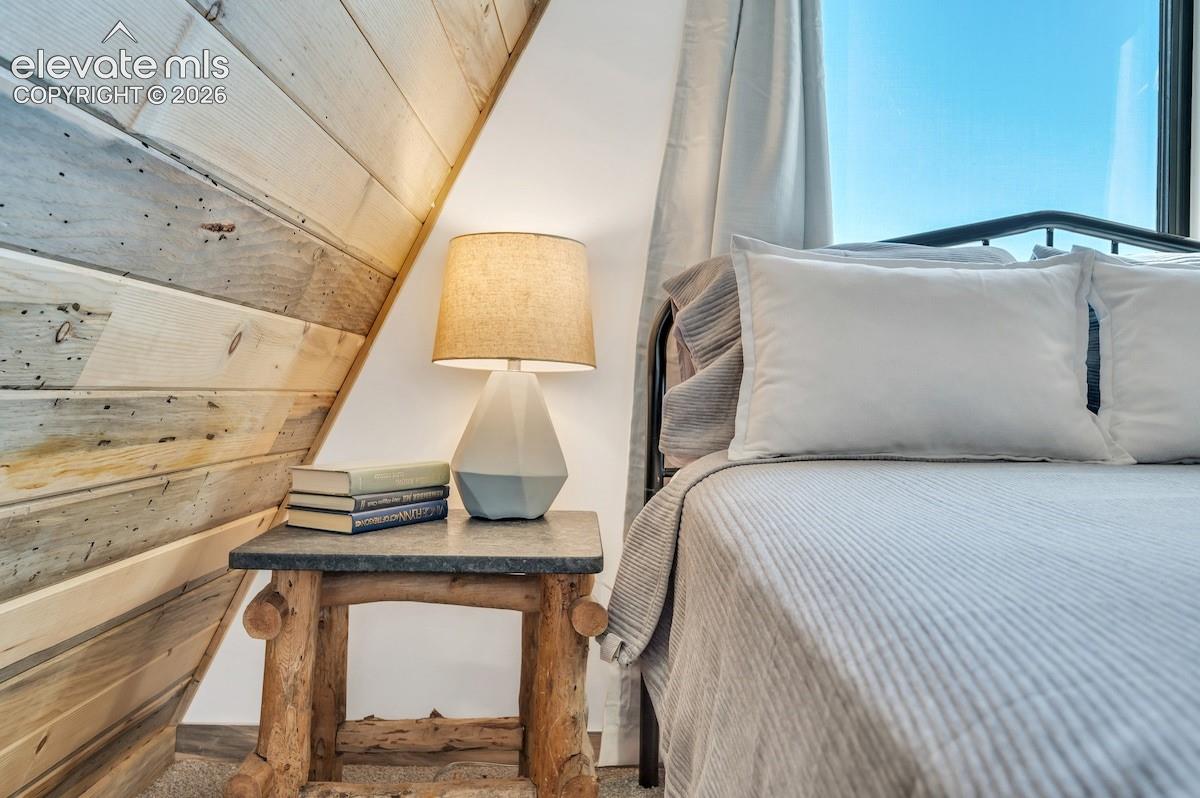 Angled wall featuring natural light-toned wood plank paneling