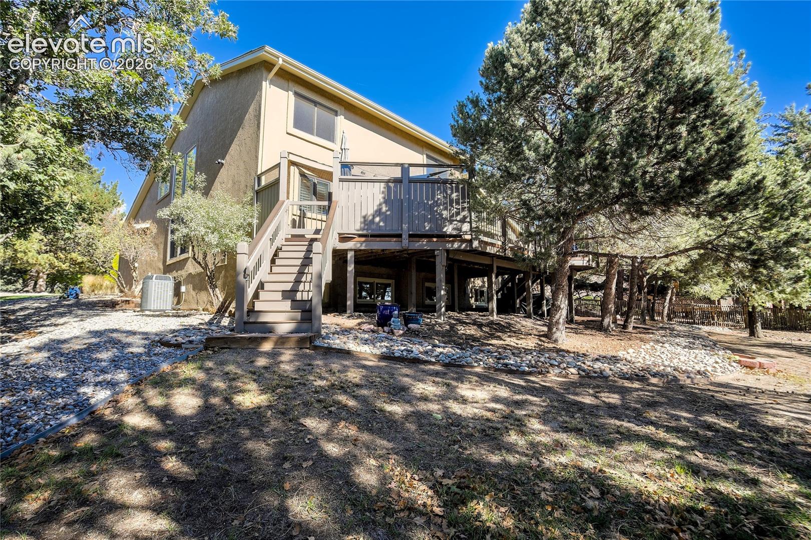 The rear elevation reveals the home's expansive Ipe deck, walk-out design + remarkable connection to the surrounding pines.