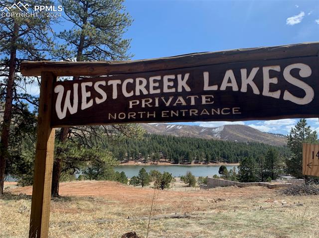 Community / neighborhood sign featuring a water and mountain view