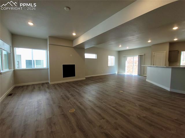 Living area features durable LVP flooring and gas fireplace