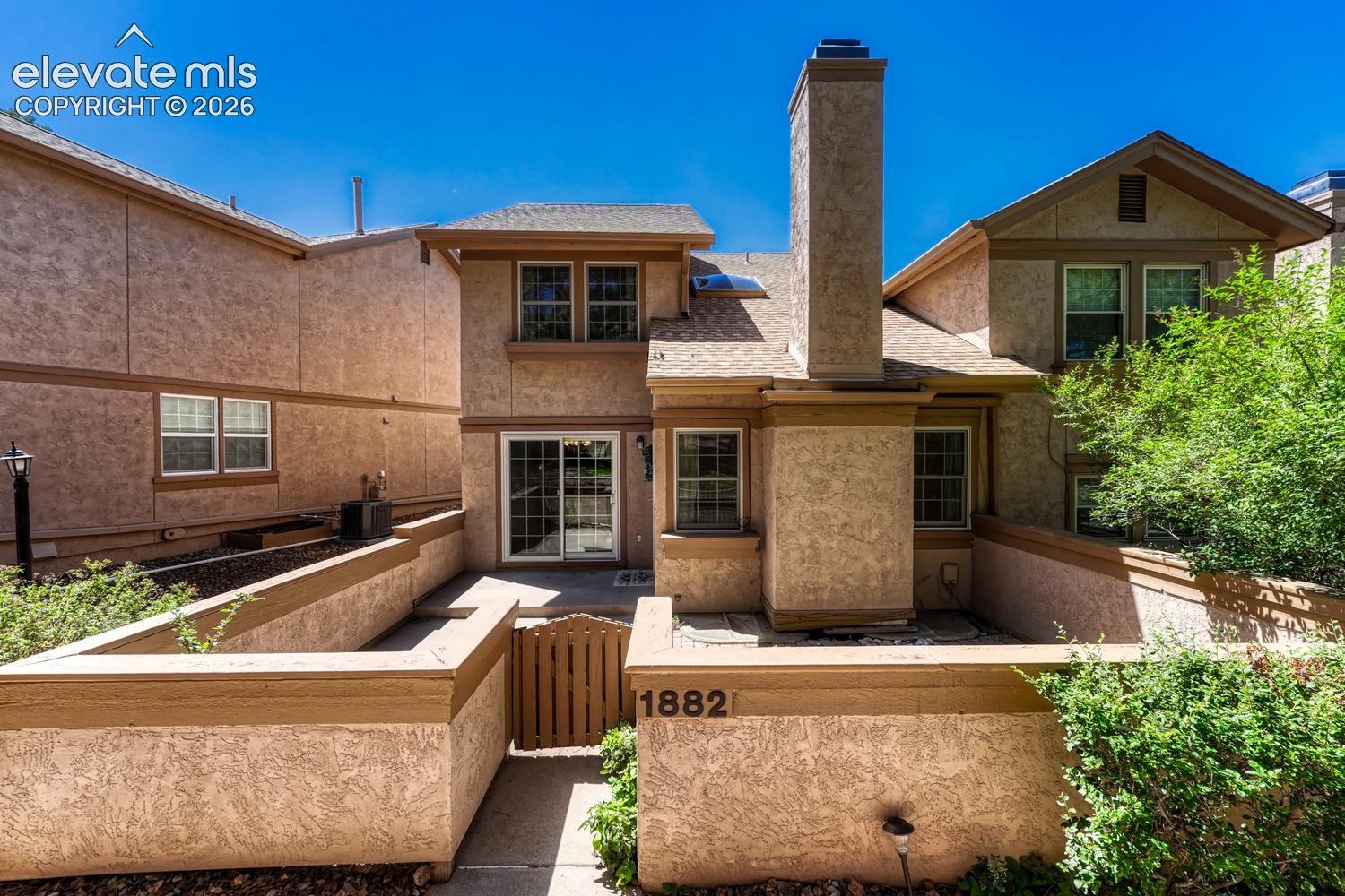 Enclosed courtyard with a concrete and paver patio for outdoor relaxation and fun.