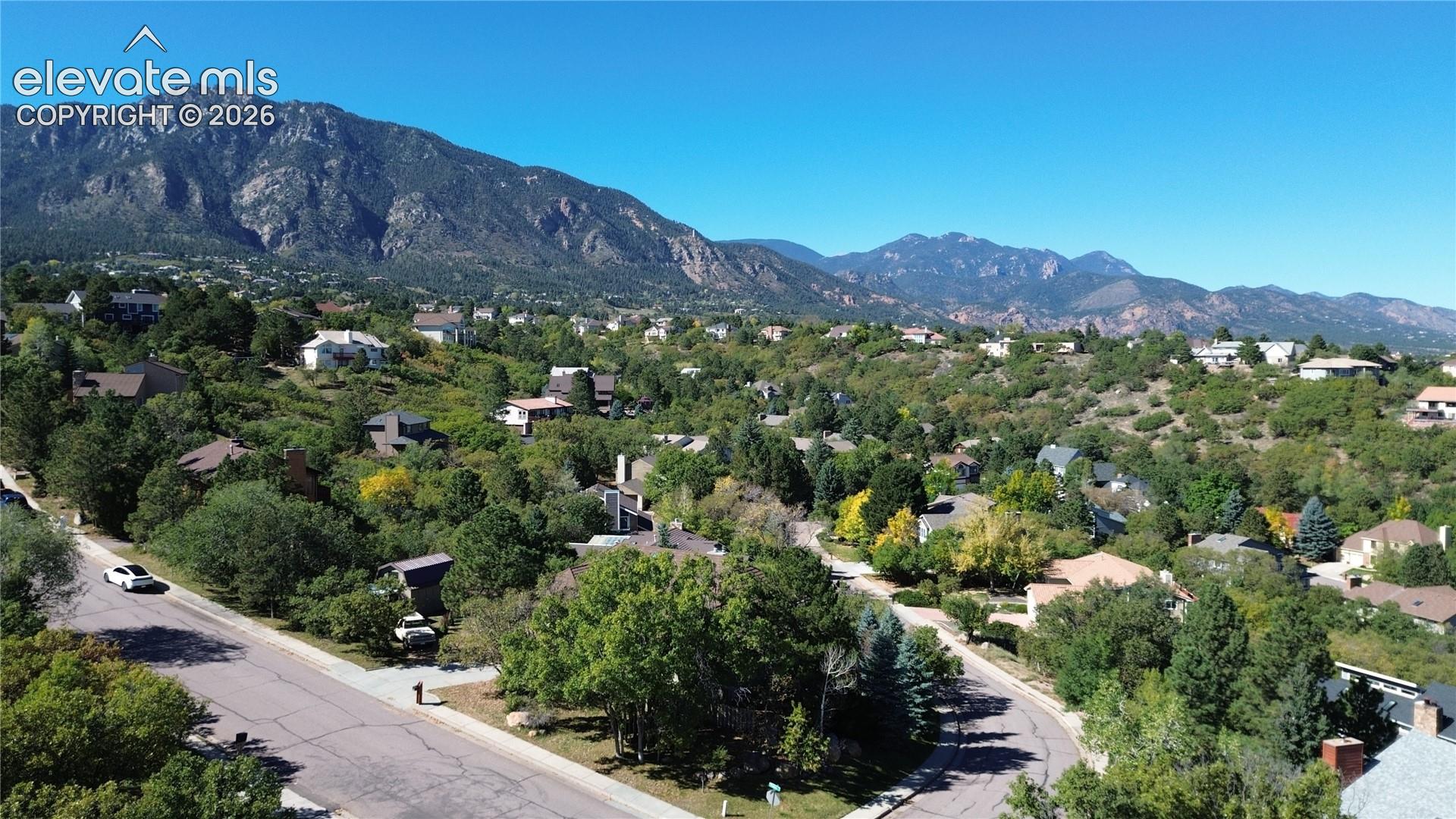 Aerial perspective featuring mountain range backdrop and mature native vegetation