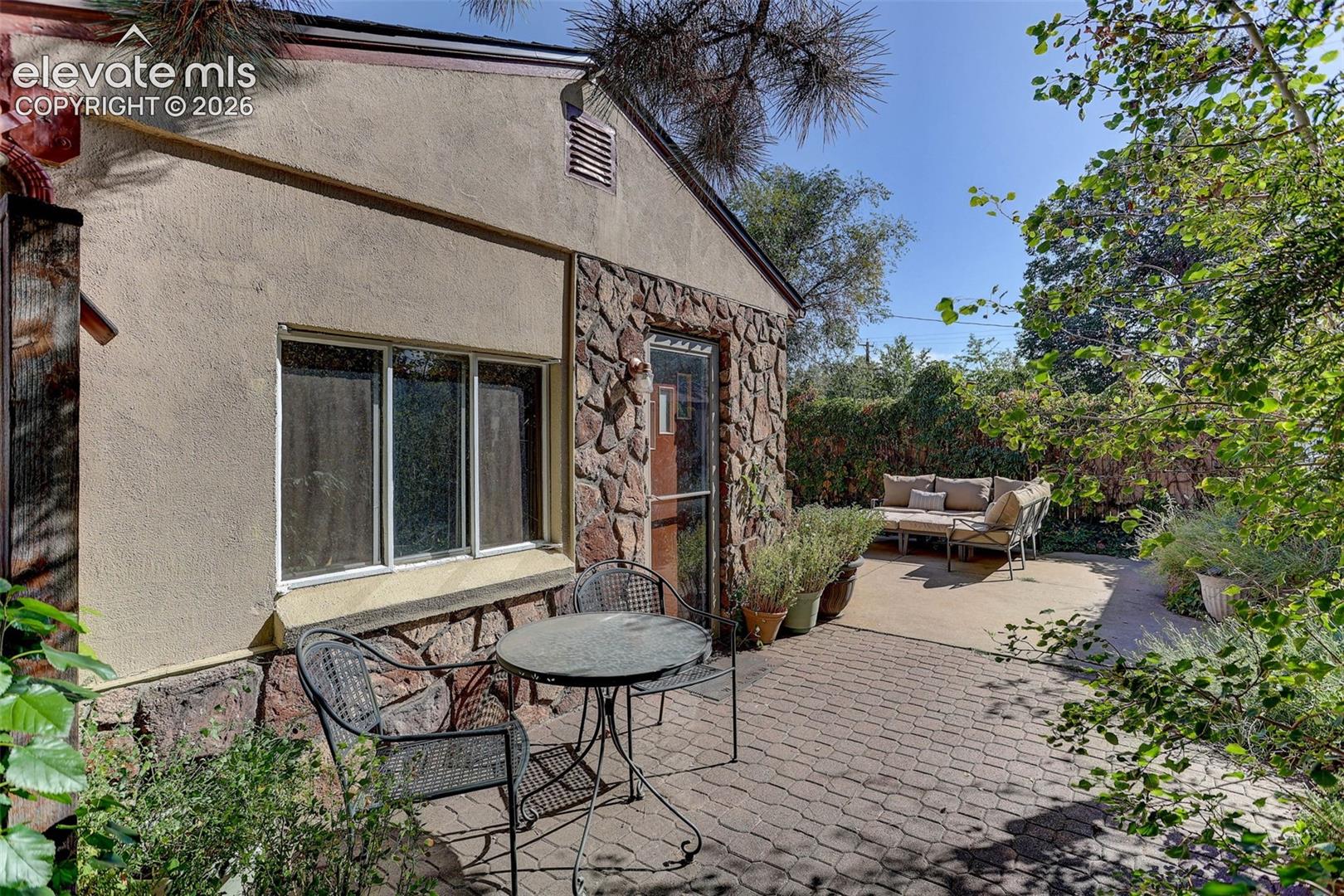Stucco and stone exterior with multi-pane windows