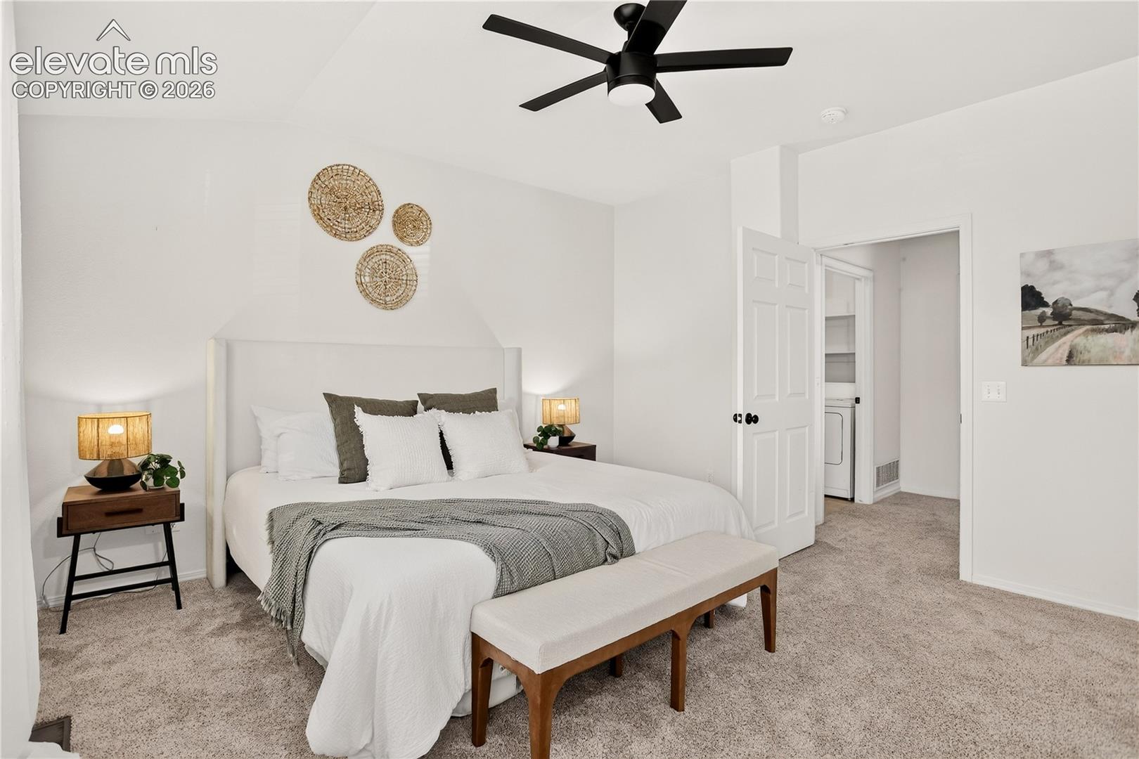 Primary (master) bedroom with ceiling fan and mountain views. Conveniently located next to laundry room.