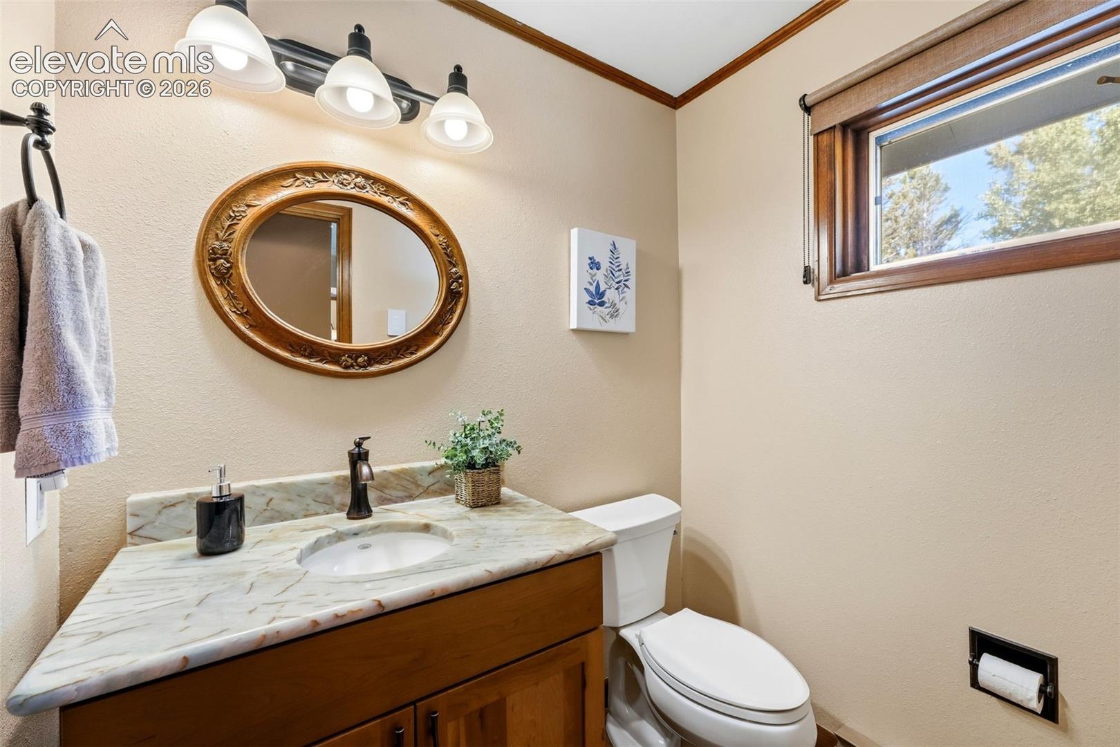 Vanity with a light-toned countertop and an undermount sink