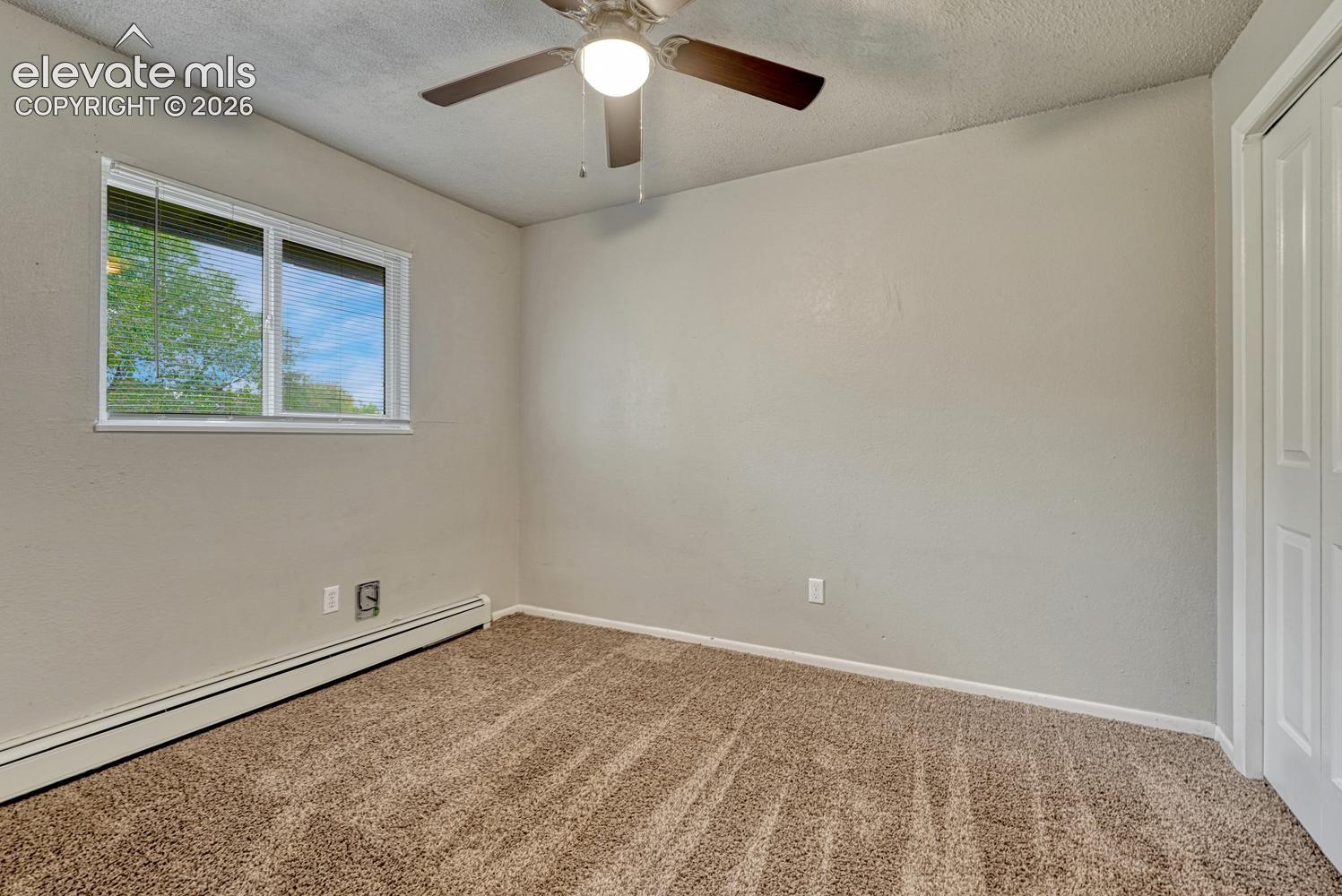 Neutral-toned walls complement the textured carpeting
