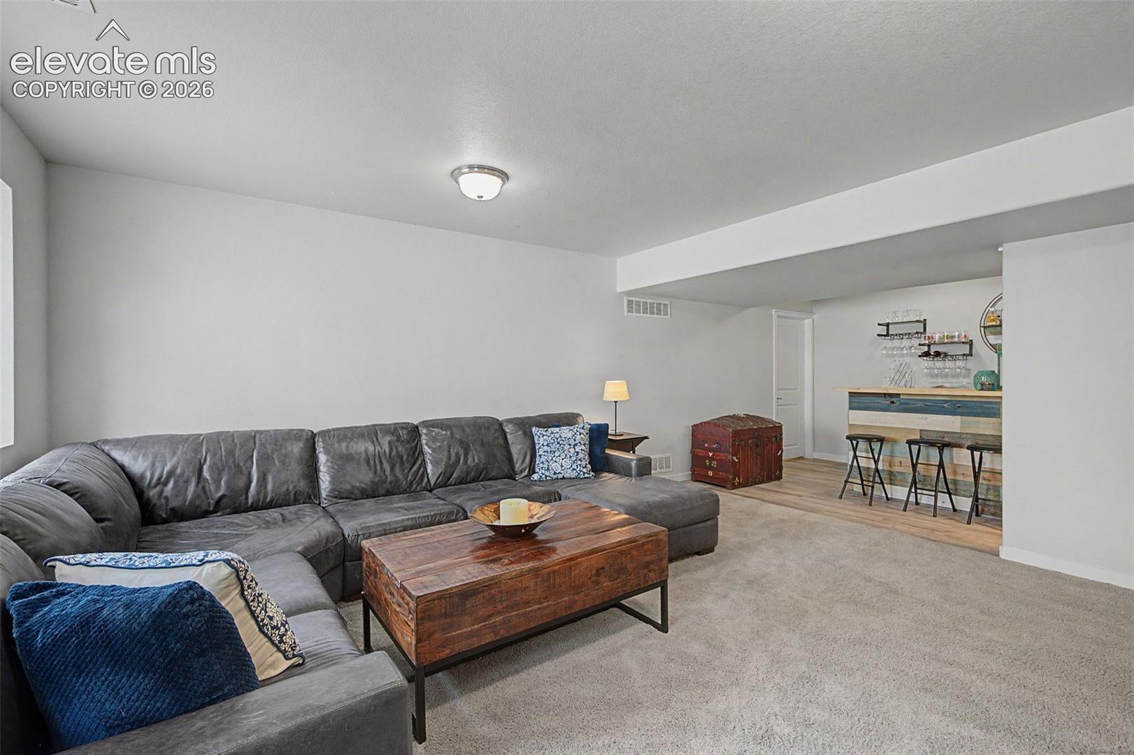 Basement family room offers a convenient wet bar to make entertaining a breeze.