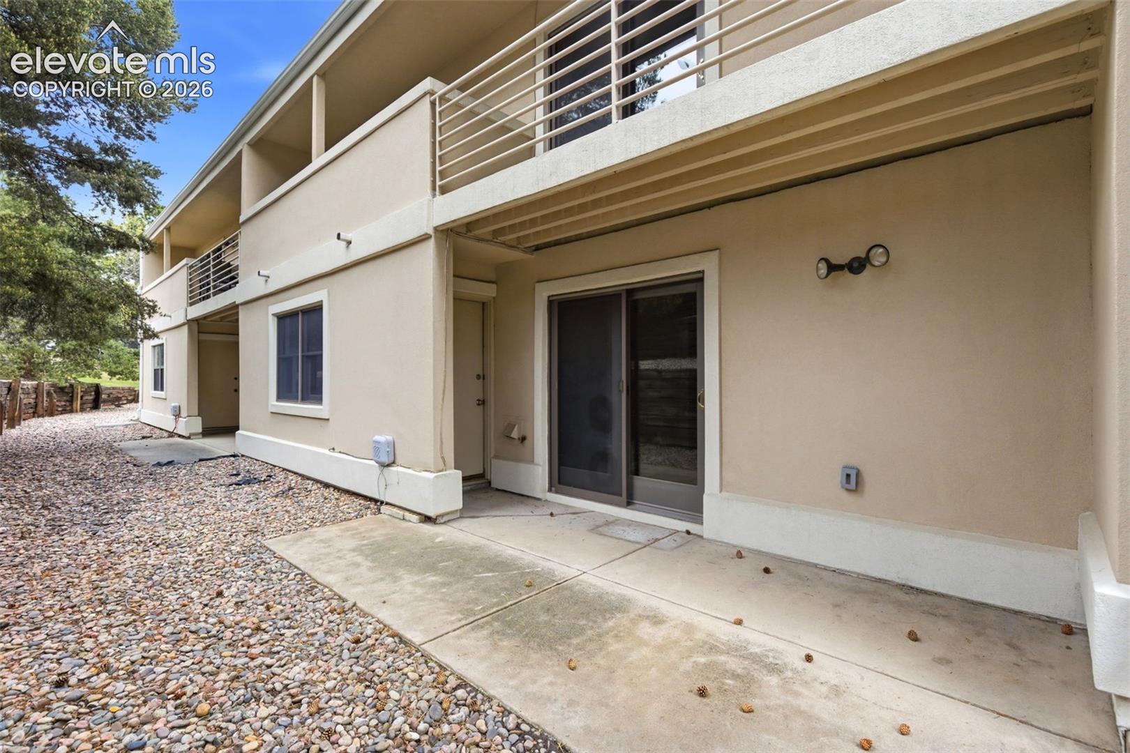 Ground-level concrete patio with direct access to a sliding glass door