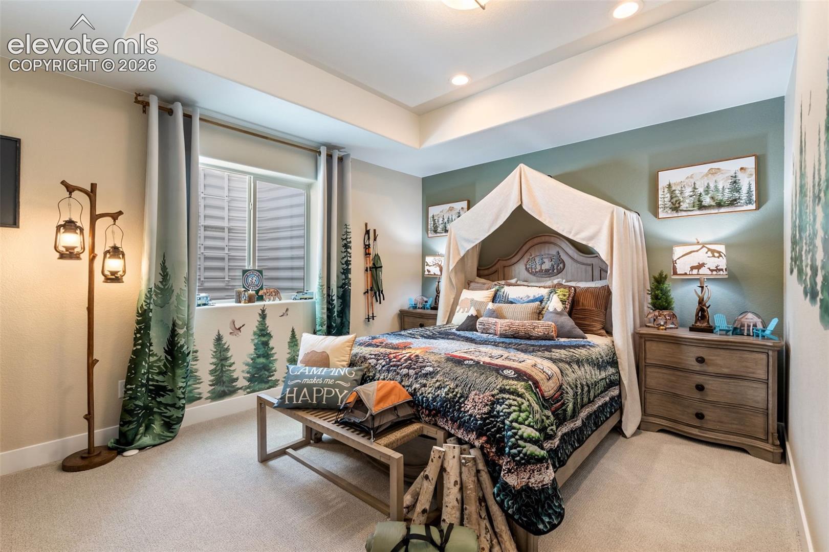 Tray ceiling, neutral carpeting, and recessed lighting