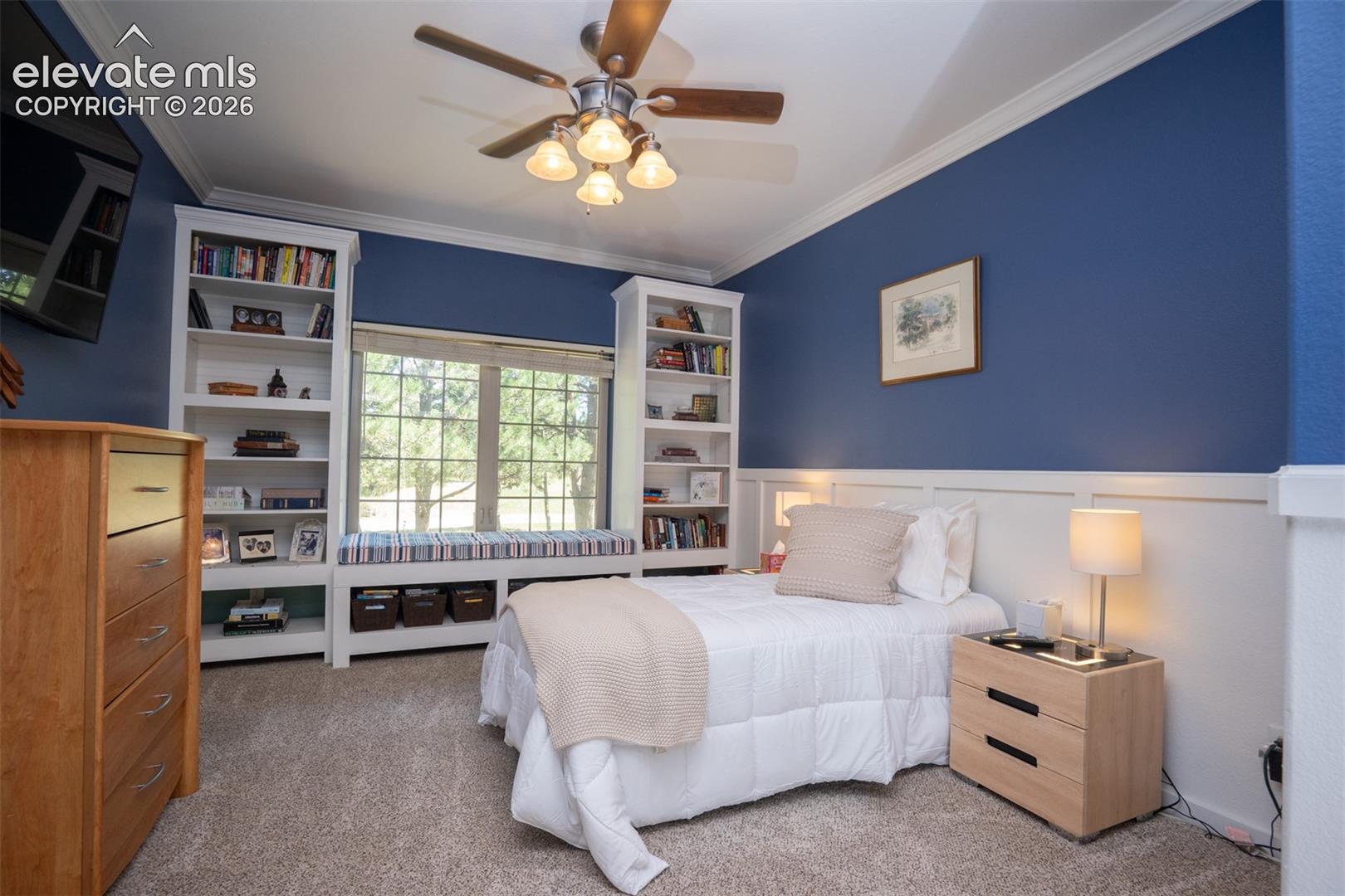 This is the 2nd bedroom off the hallway. Notice the built-in shelves, window seat, wainscoting, and crown molding. There's also a large walk-in closet and a private entrance to the hall bath.